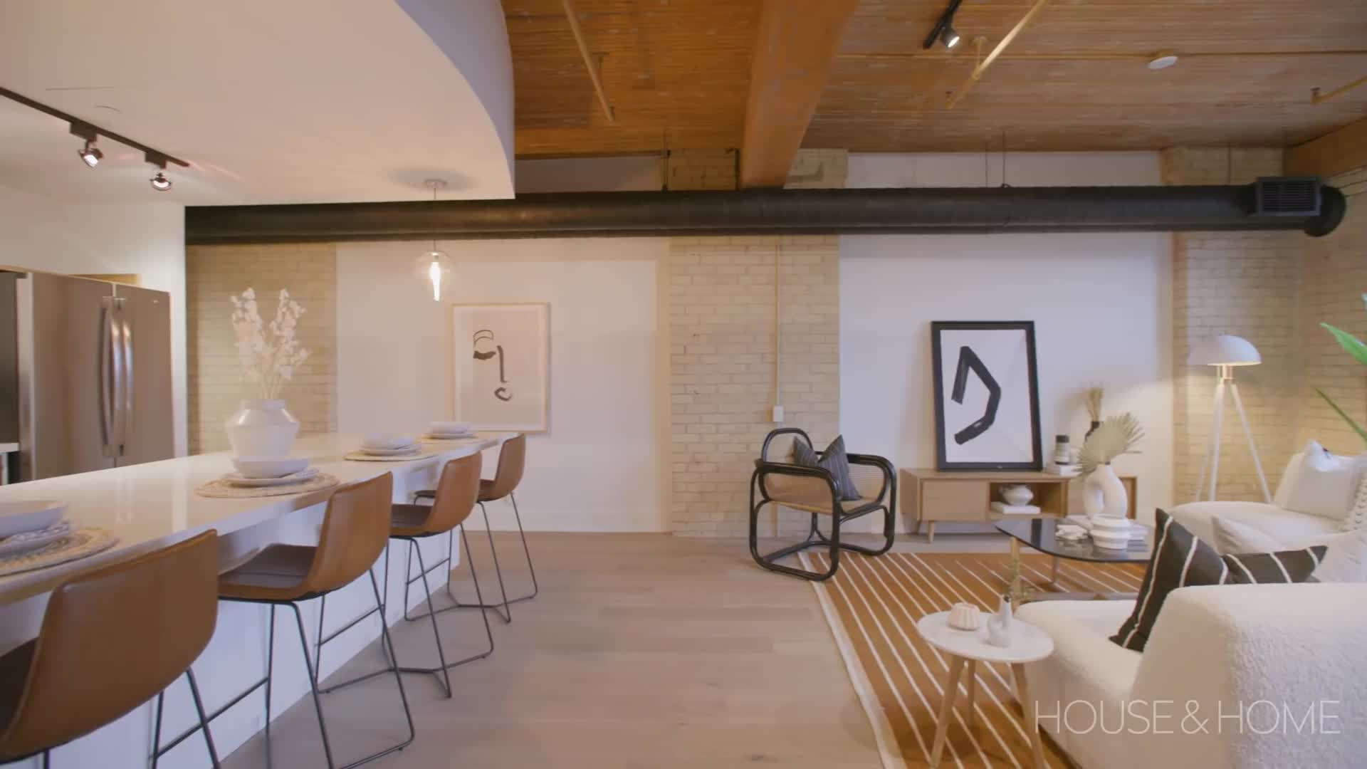Spacious living area with exposed brick walls