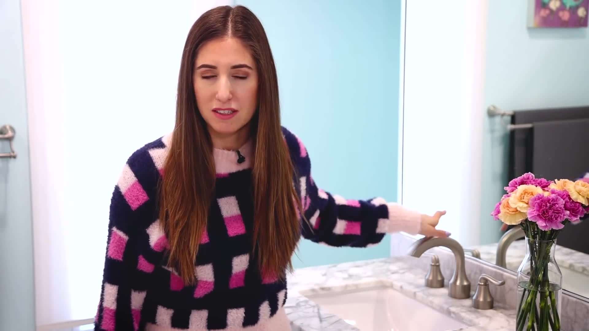 Applying disinfectant spray on the cleaned sink