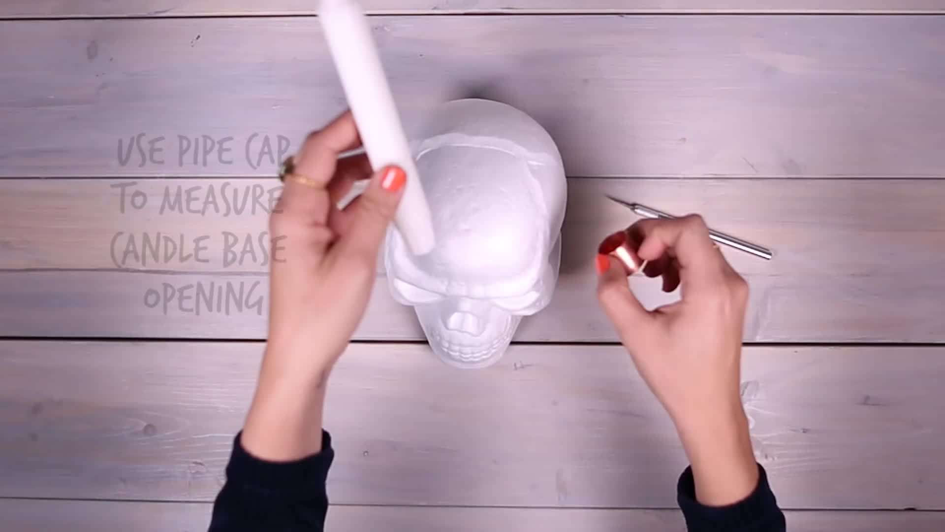 Spray painting the skull candle holders white