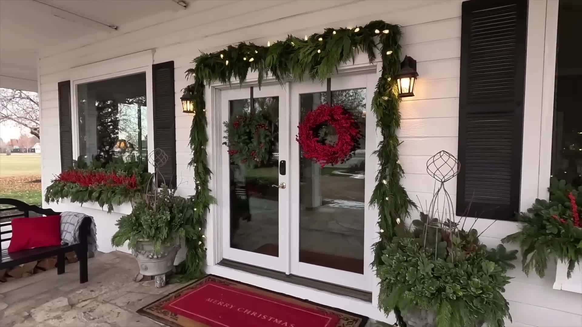 Tall evergreen plants placed in the center of the windowbox