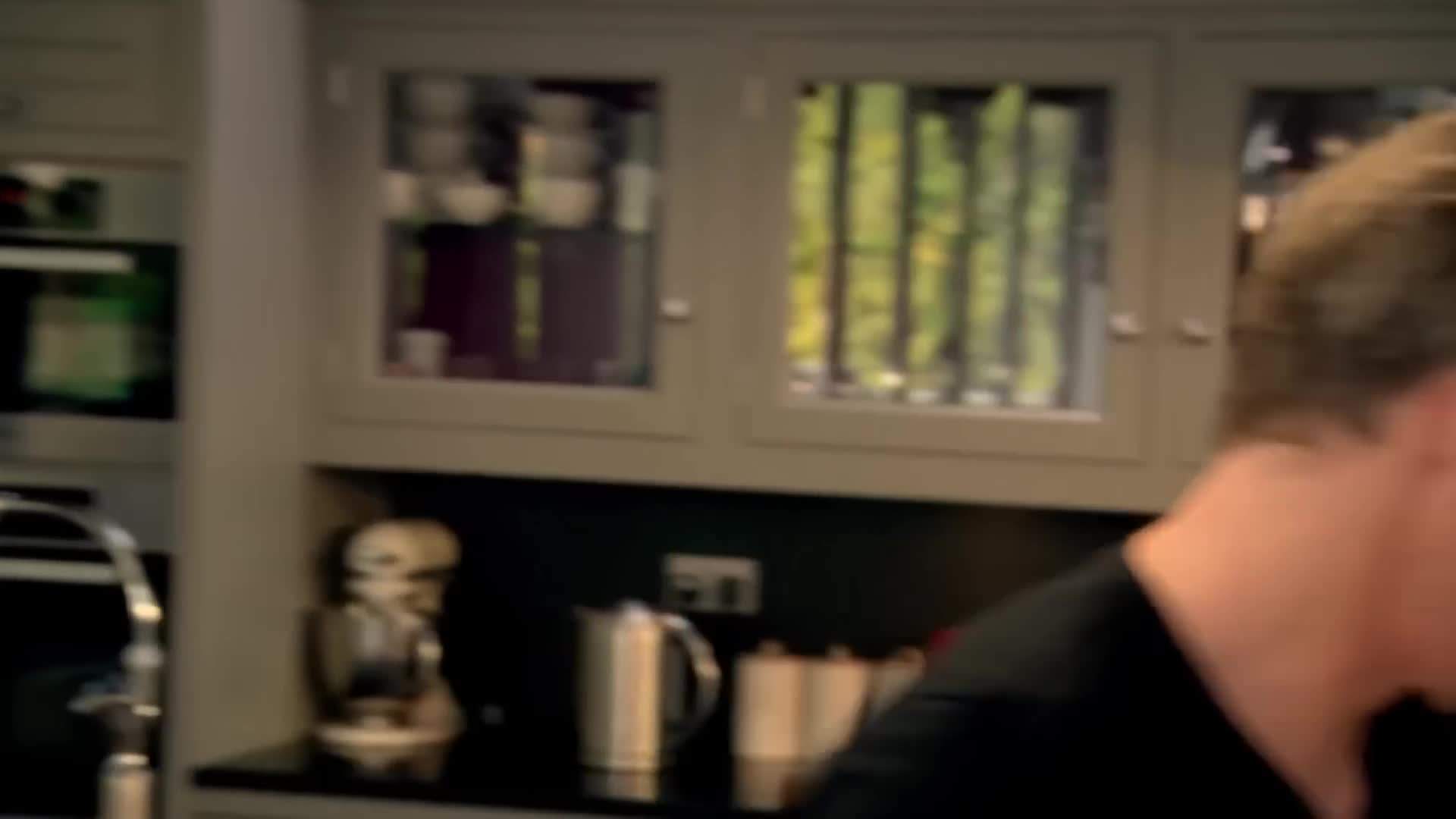 Gordon Ramsay using a chef's knife to chop ingredients