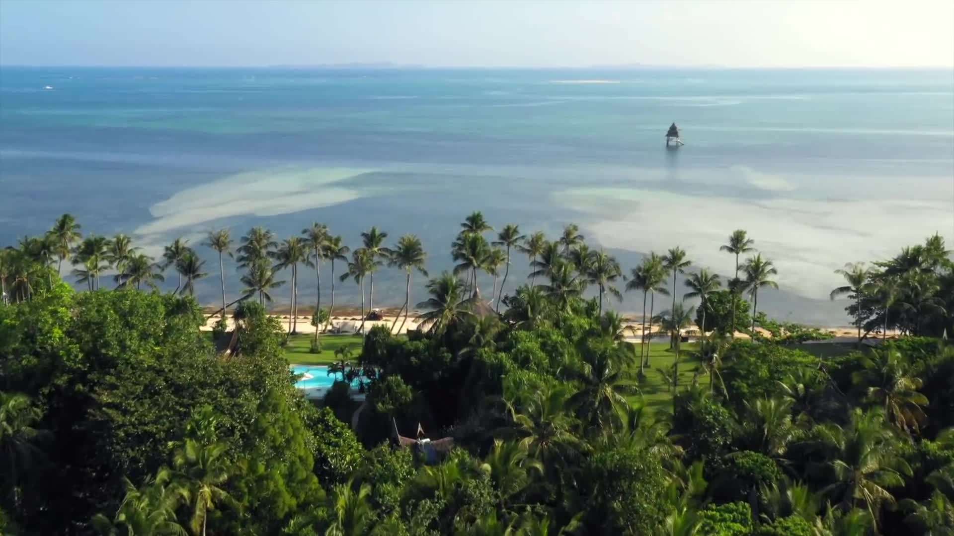 Surfers catching waves at Cloud 9, Siargao's famous surf spot
