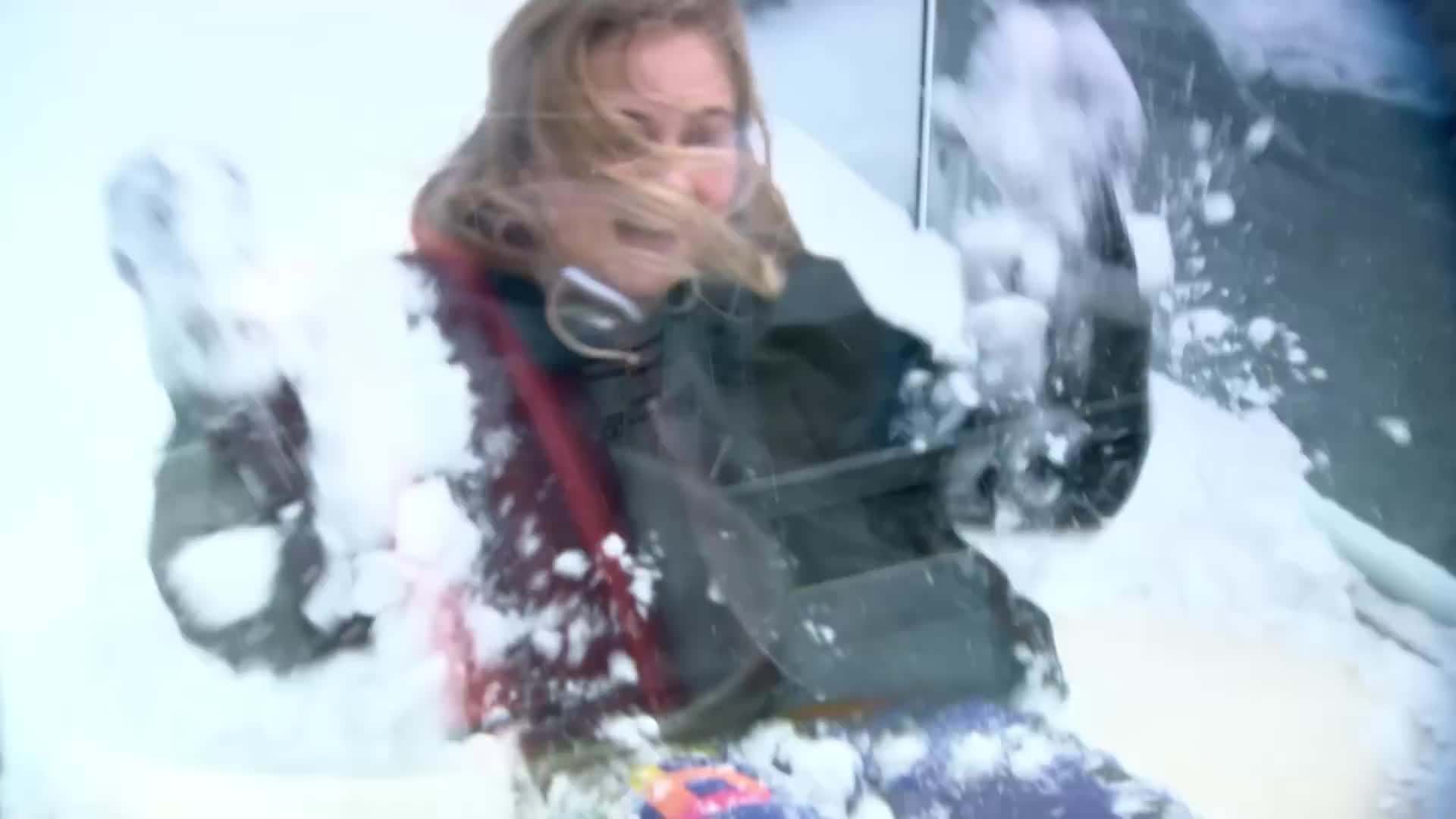 Generously spooning hollandaise sauce over the Eggs Benedict