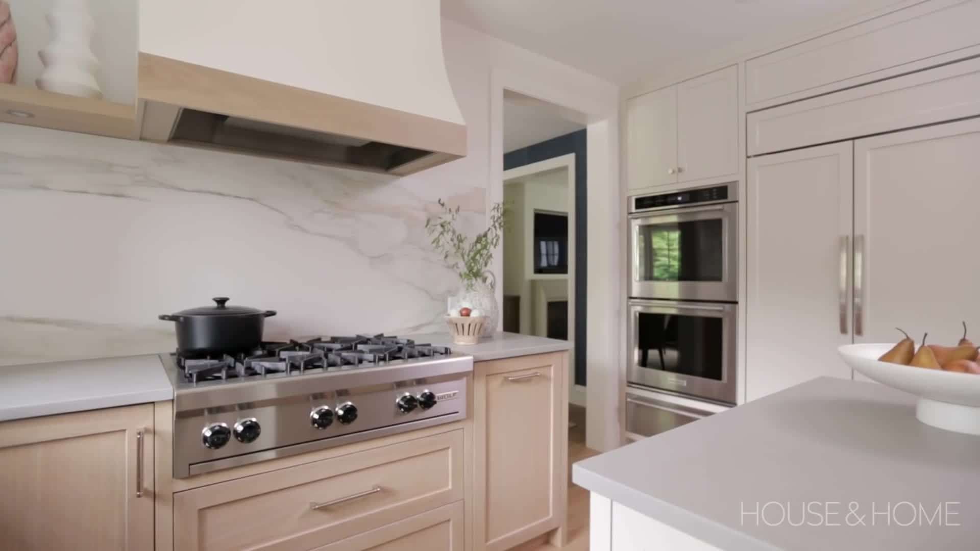 Integrated kitchen and dining area with glass doors leading to the backyard