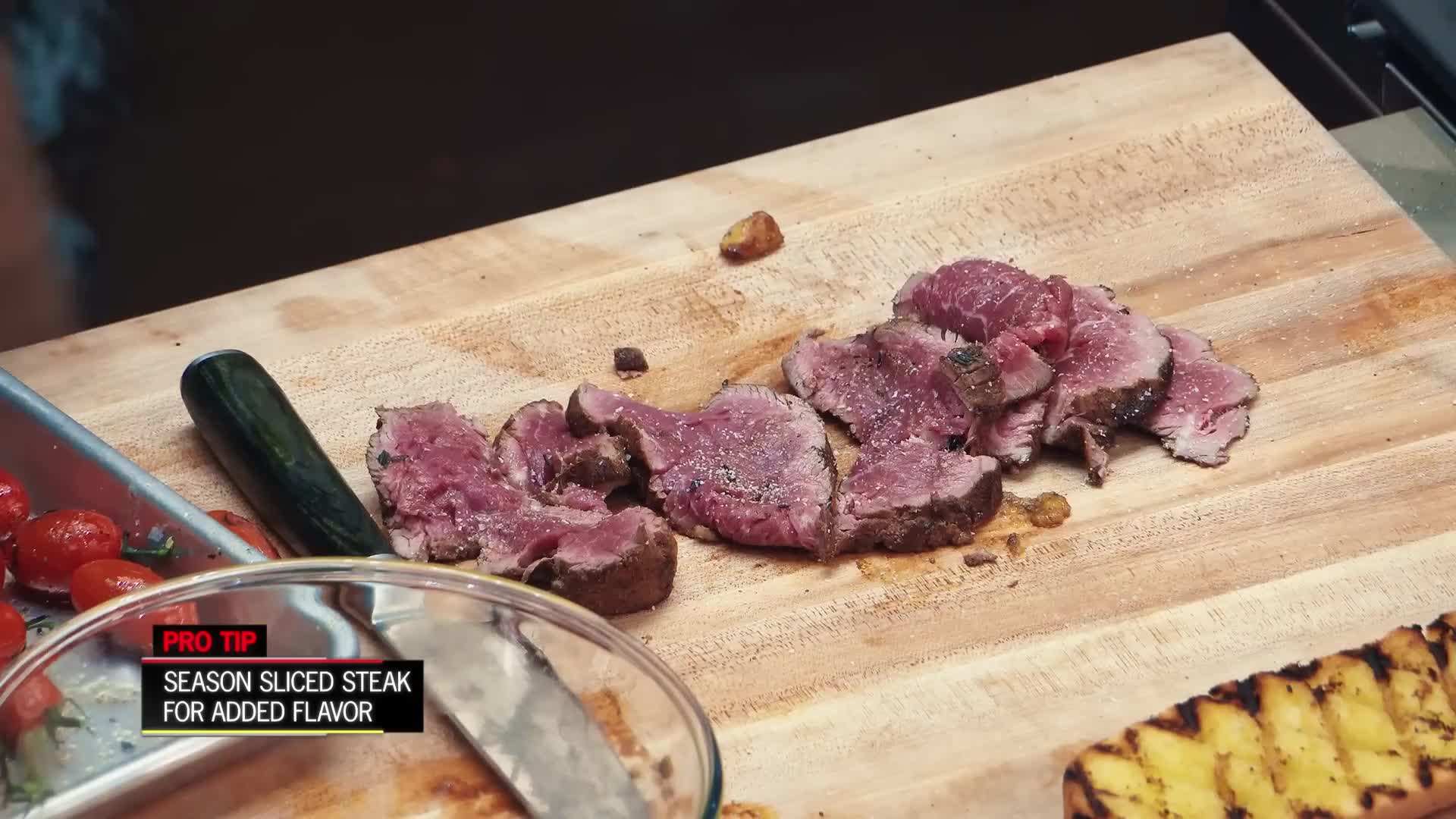 Layering the sliced steak onto the bread