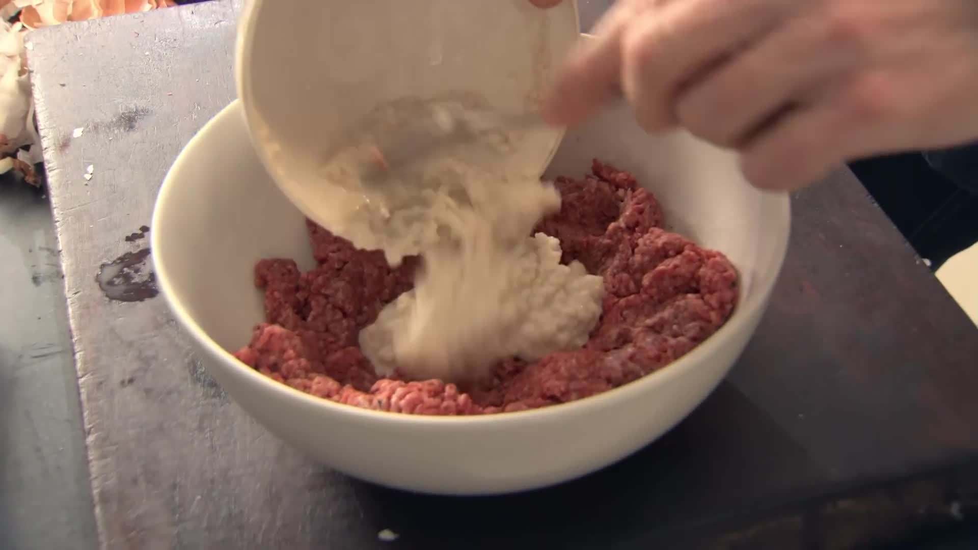 Gordon Ramsay shaping the ground beef into meatballs
