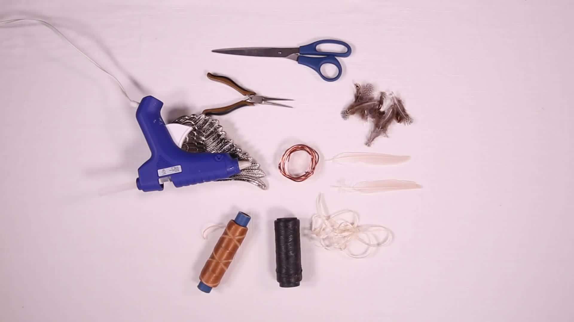 Embroidery hoop, embroidery thread, feathers, and beads for DIY Mini Dreamcatcher Ornament