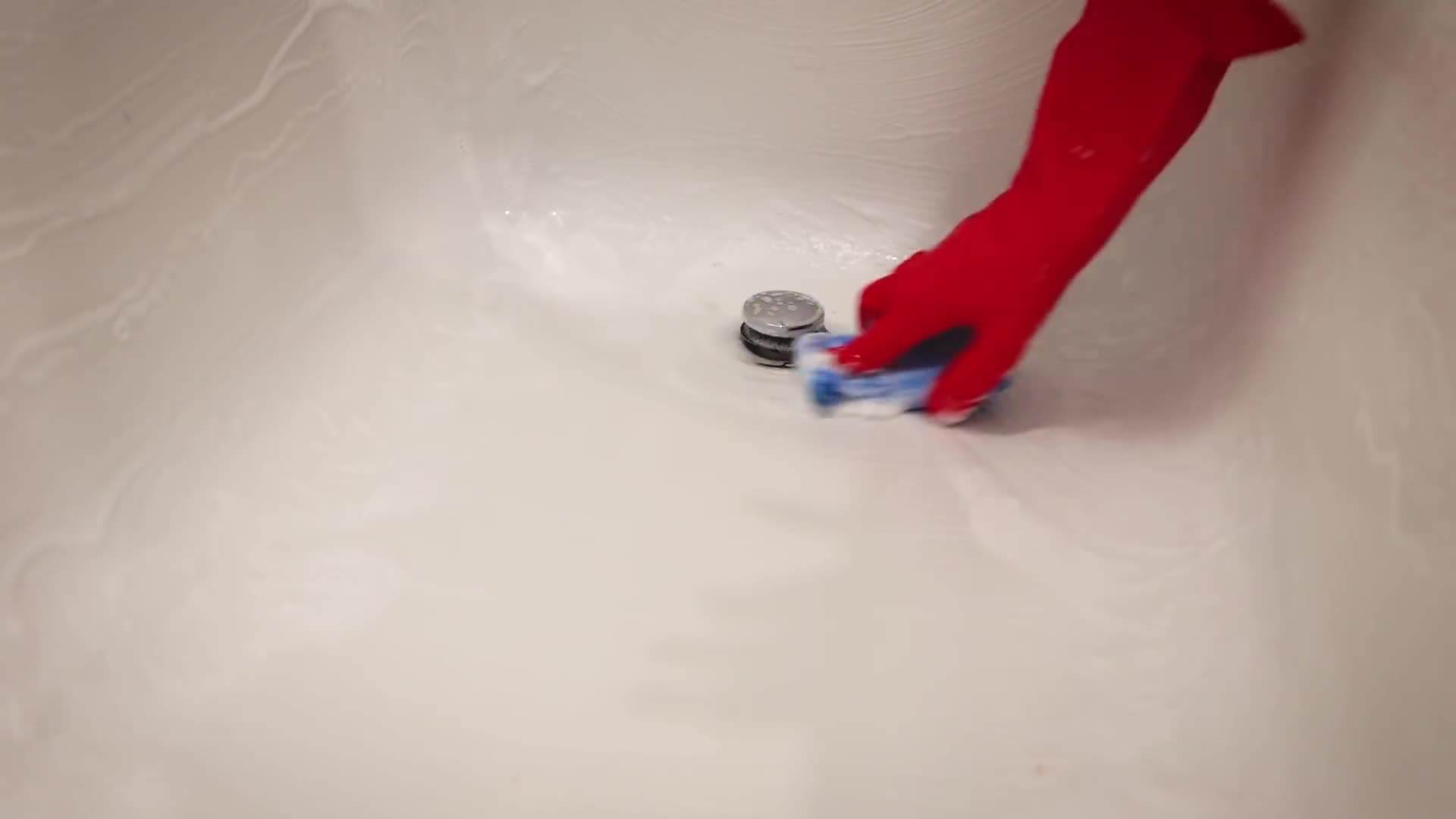 Applying bathtub cleaner to remove soap scum