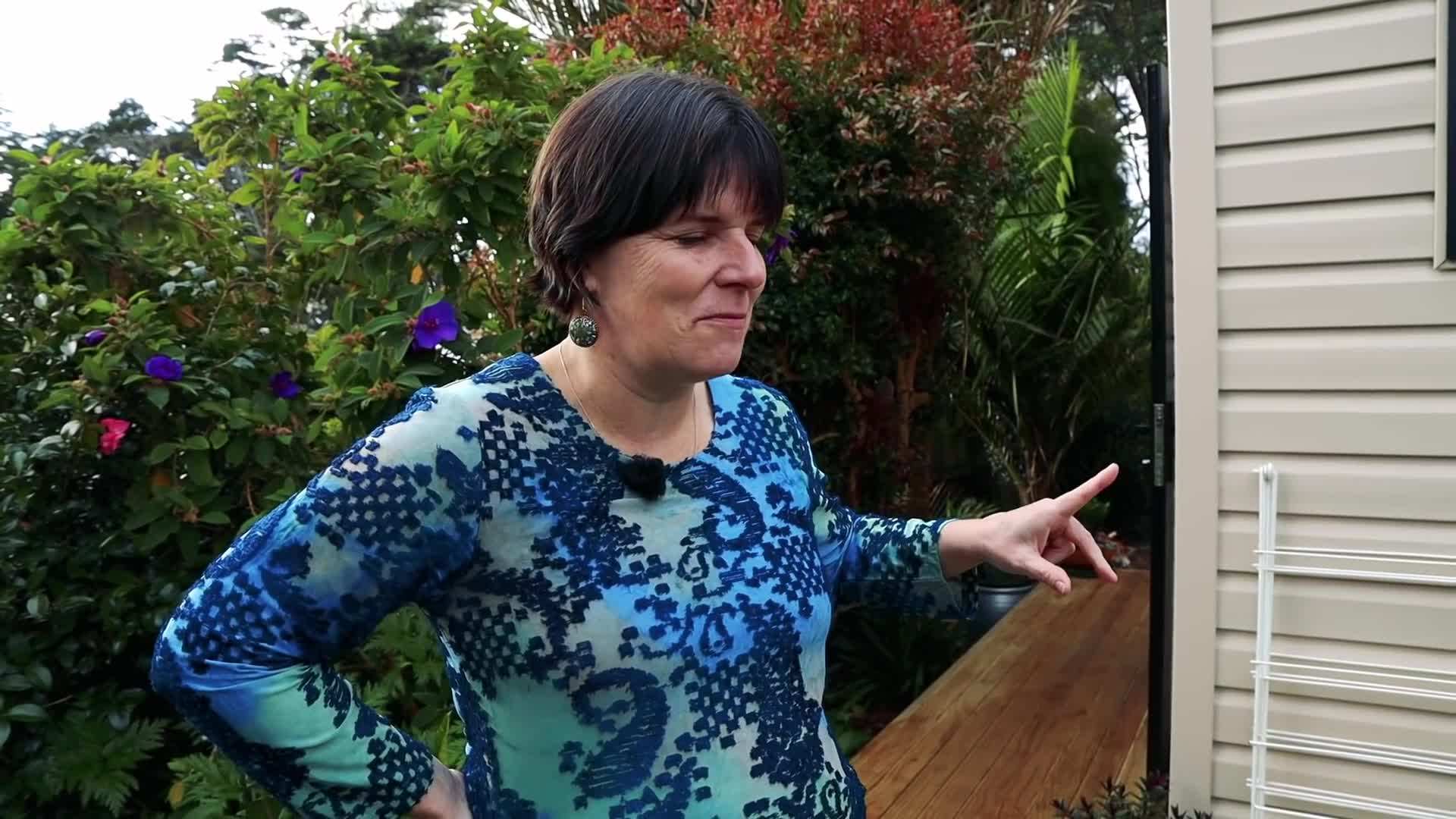 Michelle showcasing the interior of her tiny house