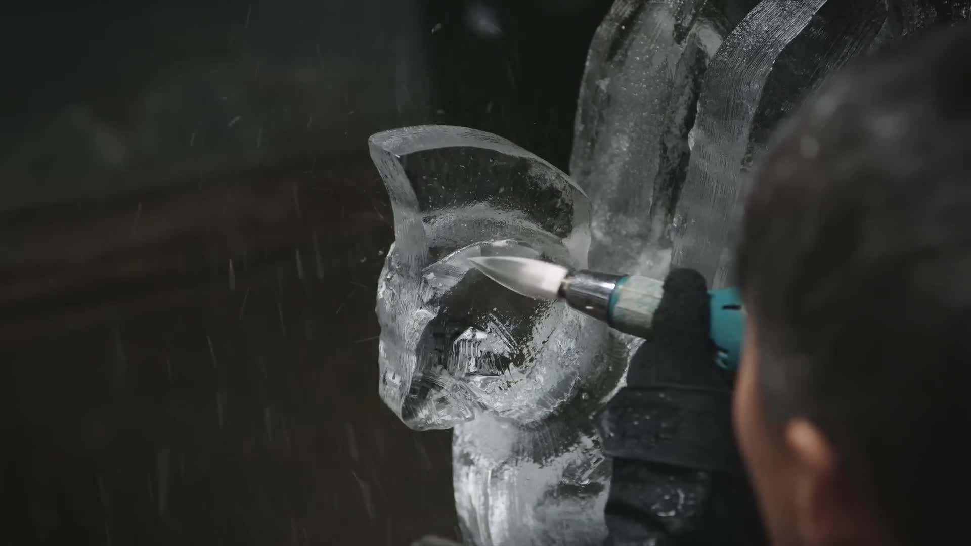 Okamoto carving the fine details of the cockatoo's feathers