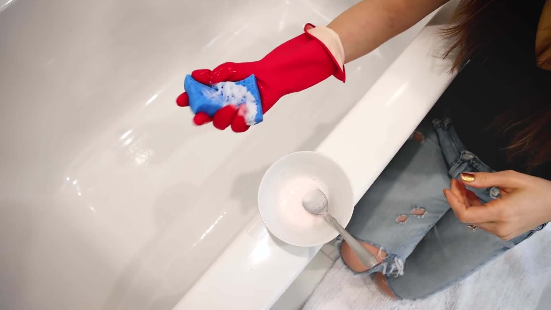 Melissa Maker demonstrating the use of a bathtub cleaner