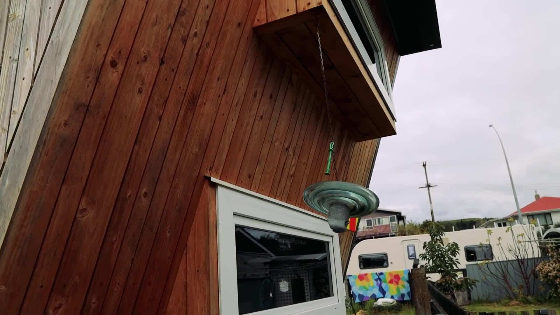 Bobbie showcasing the kitchen area of the tiny house