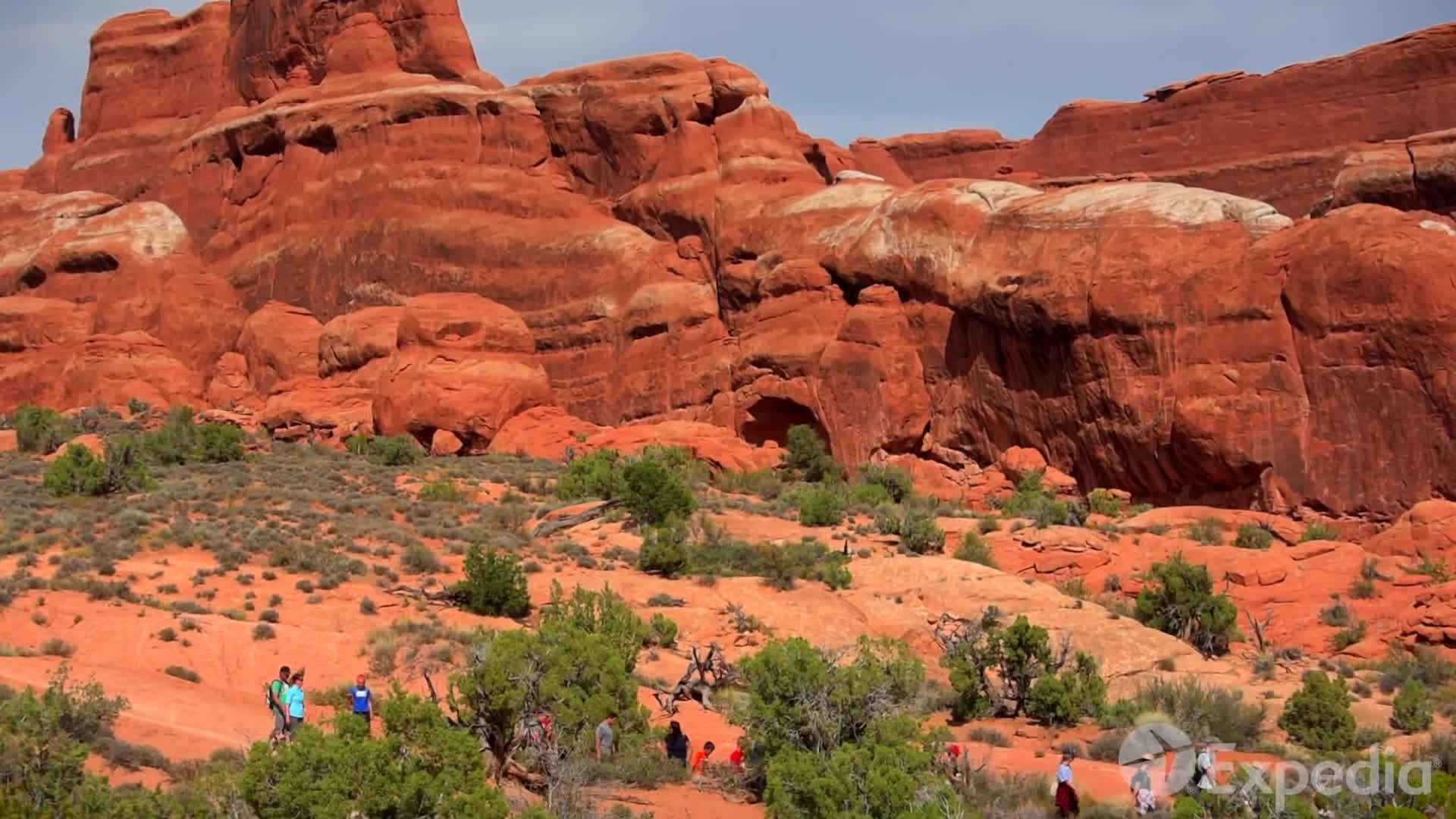 A hiker exploring a scenic viewpoint with binoculars