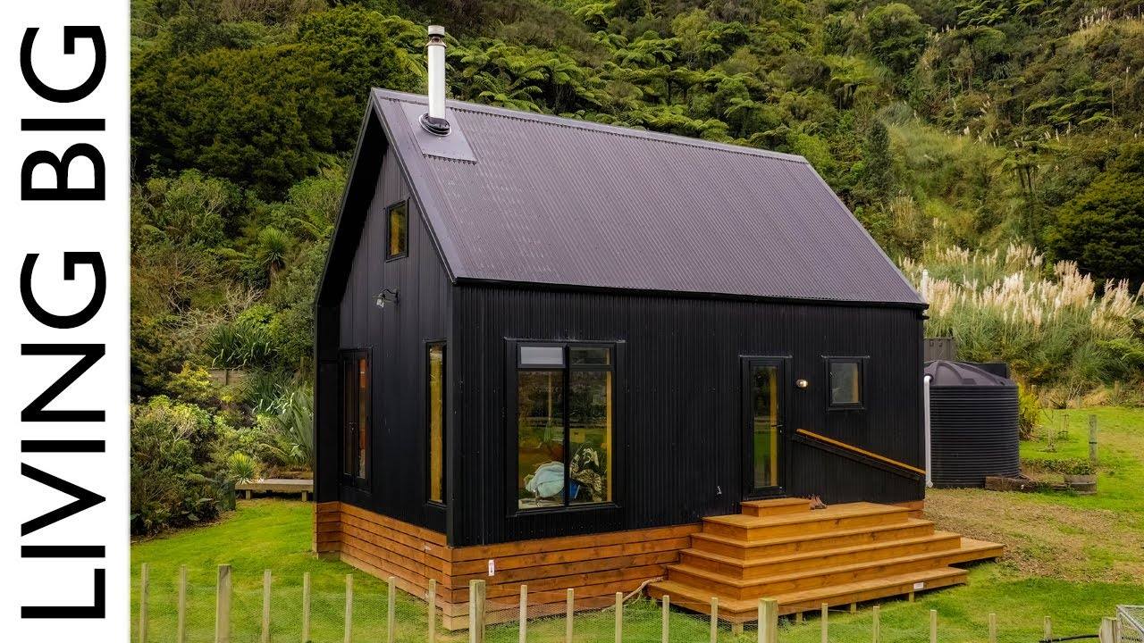 Living Off-The-Grid: Discover a Stunning Black Cabin By The River