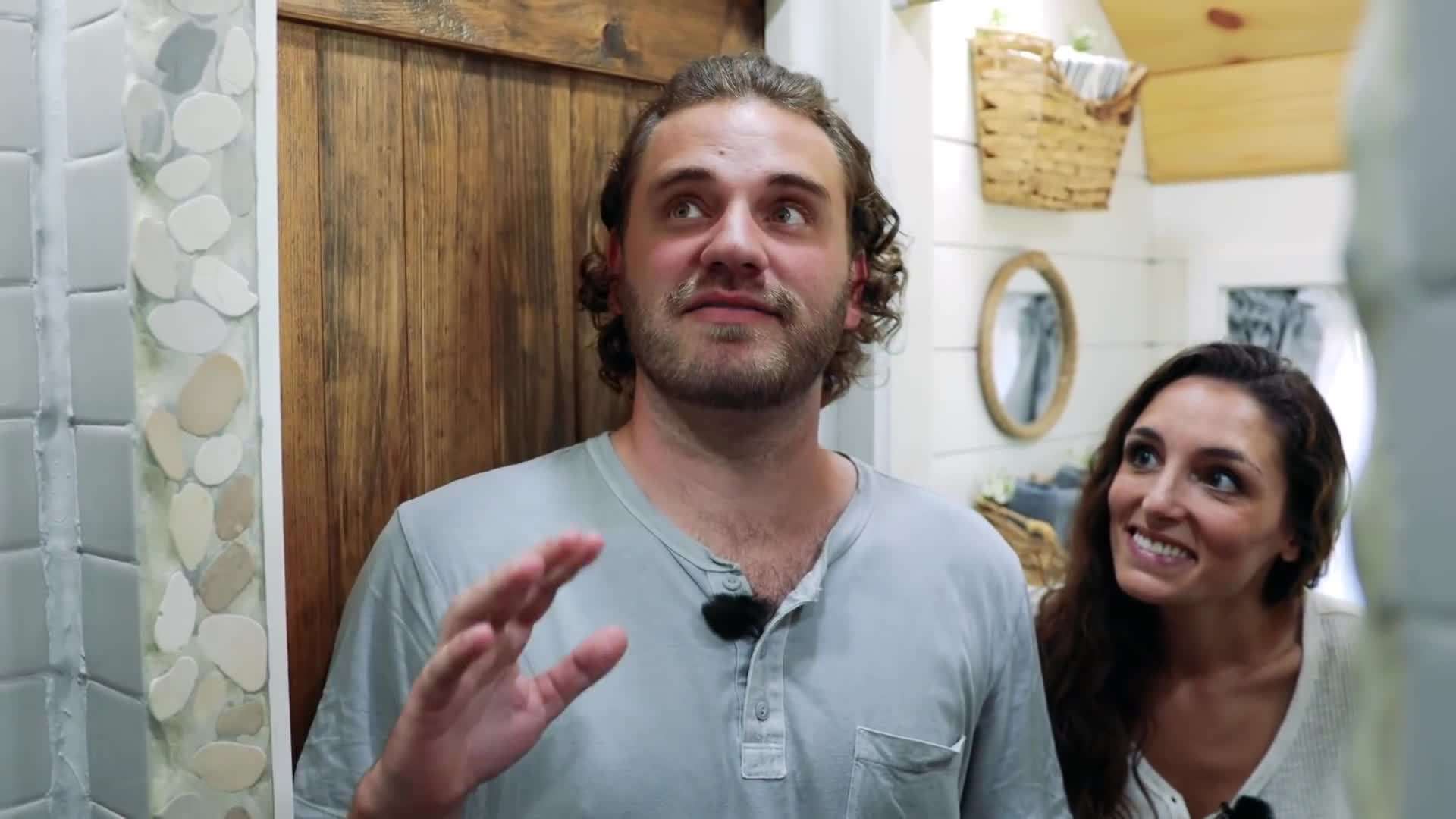 Aerial shot of the bus by the beach, surrounded by nature