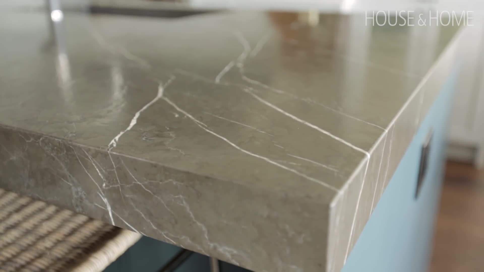 The rich blue-green island with a leathered granite countertop