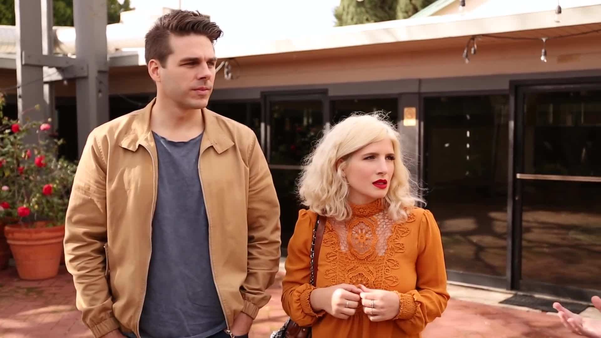 Using painter's tape and stencils to create a geometric pattern on the wall