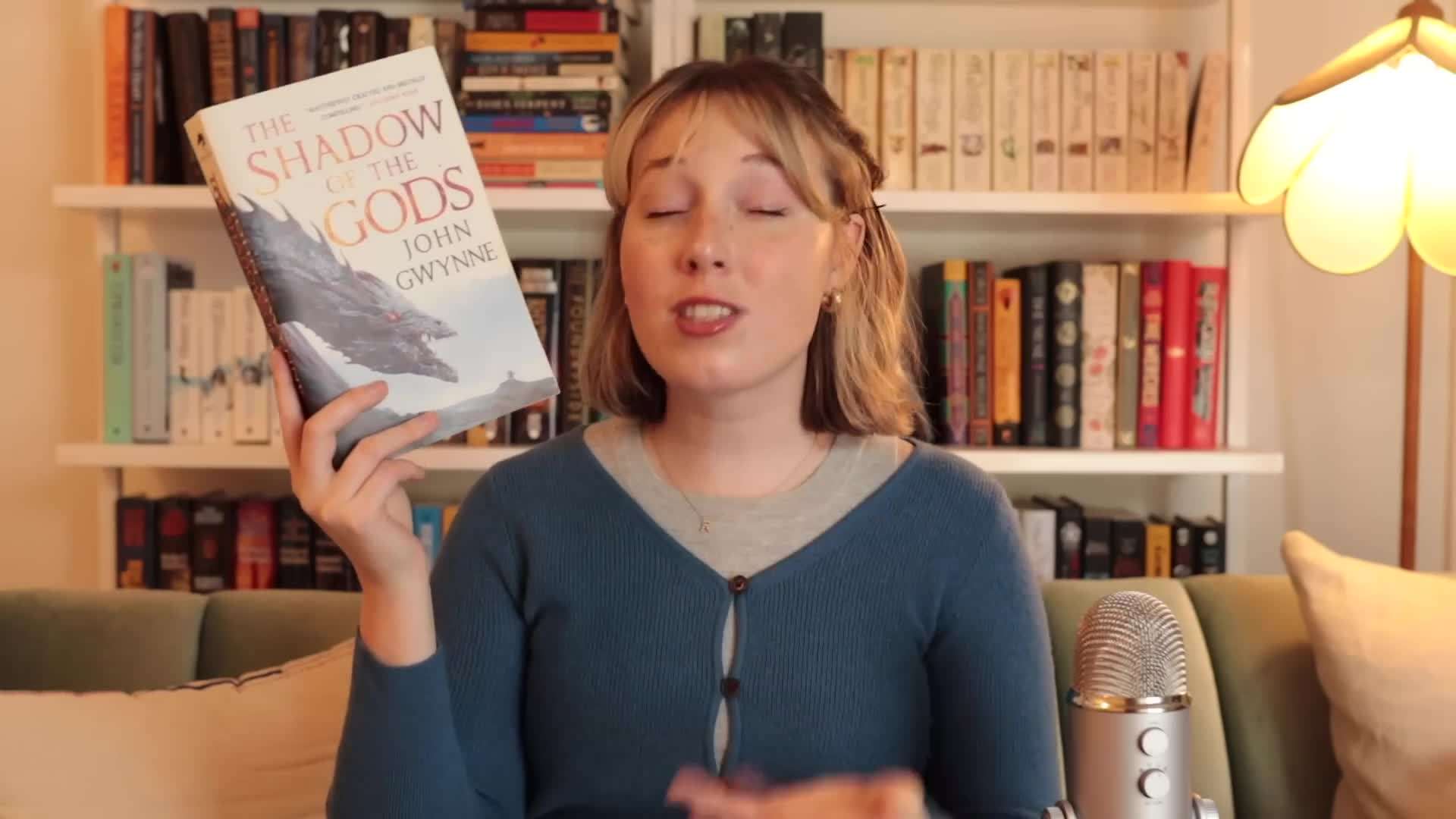 Bookshelves filled with fantasy novels including A Deadly Education