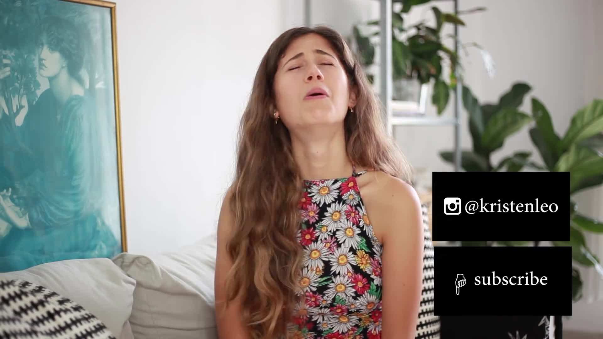 Kristen trying on a vintage denim jacket at a thrift store