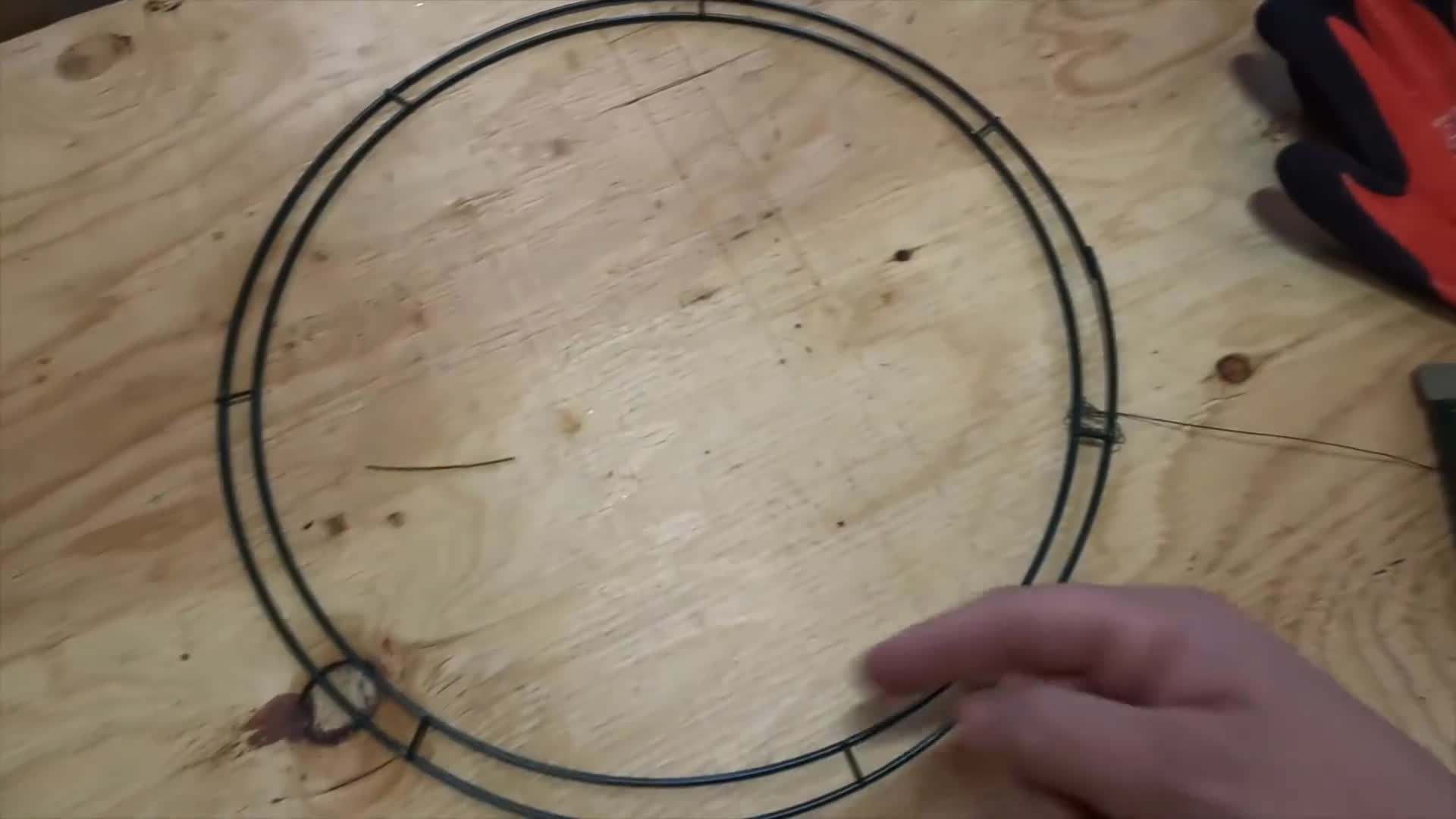 Attaching greenery and decorations to the wreath base