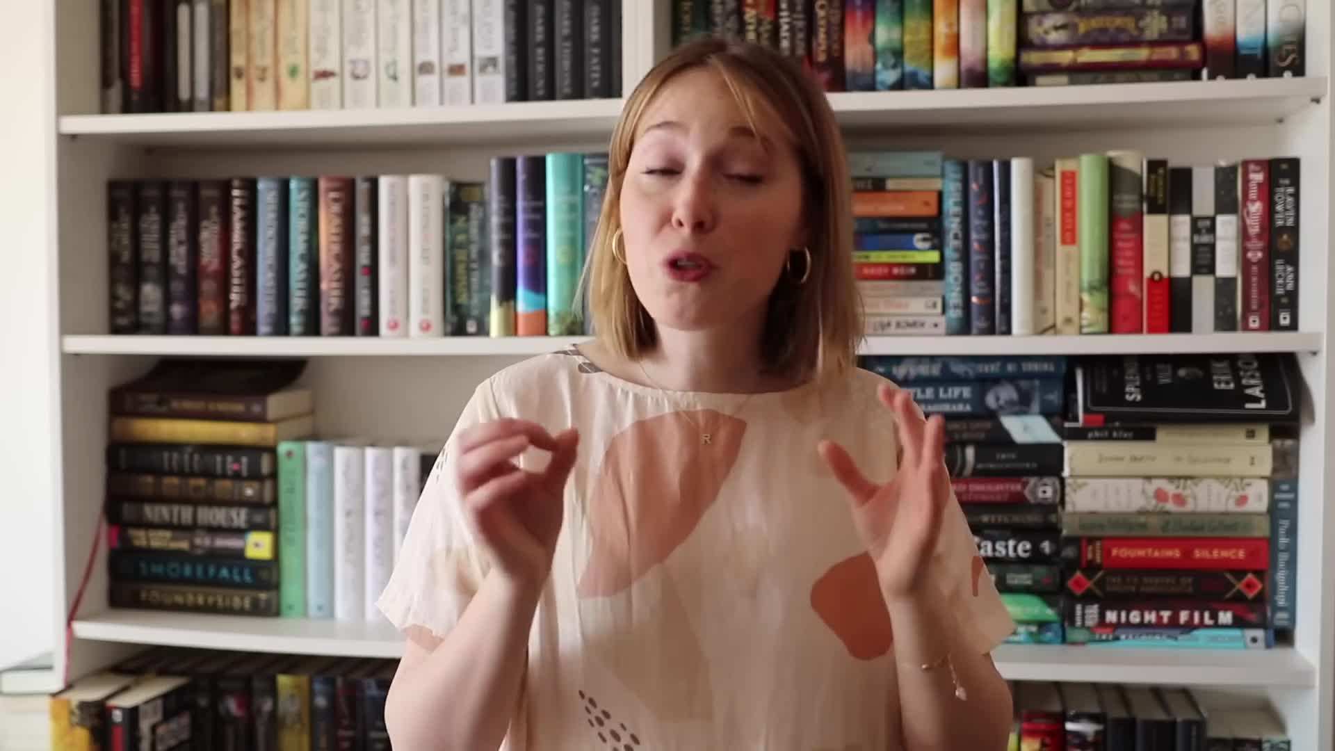 Meticulously organized bookshelves with different genre sections