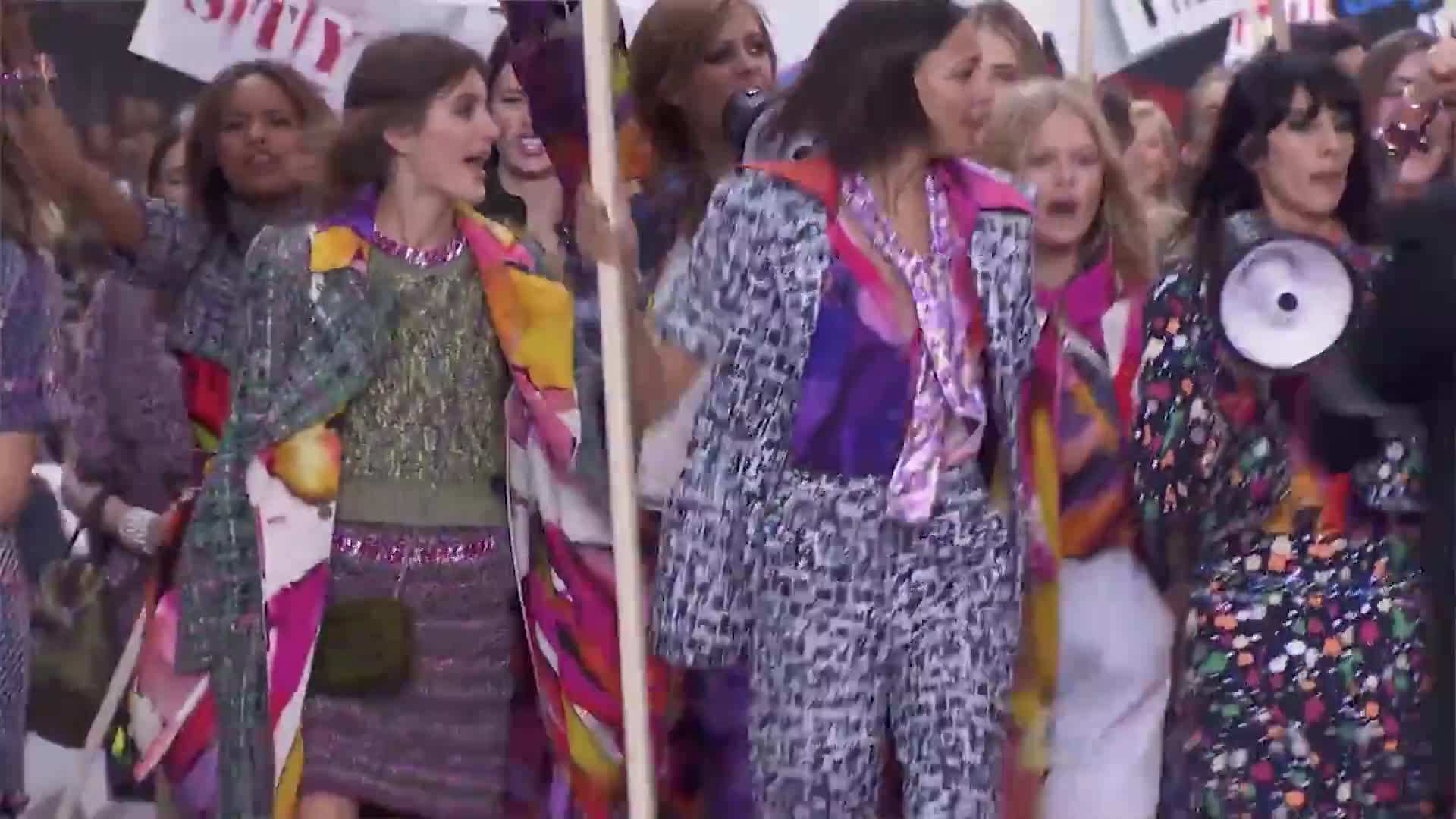 Kristen holding a fast fashion t-shirt with a feminist slogan