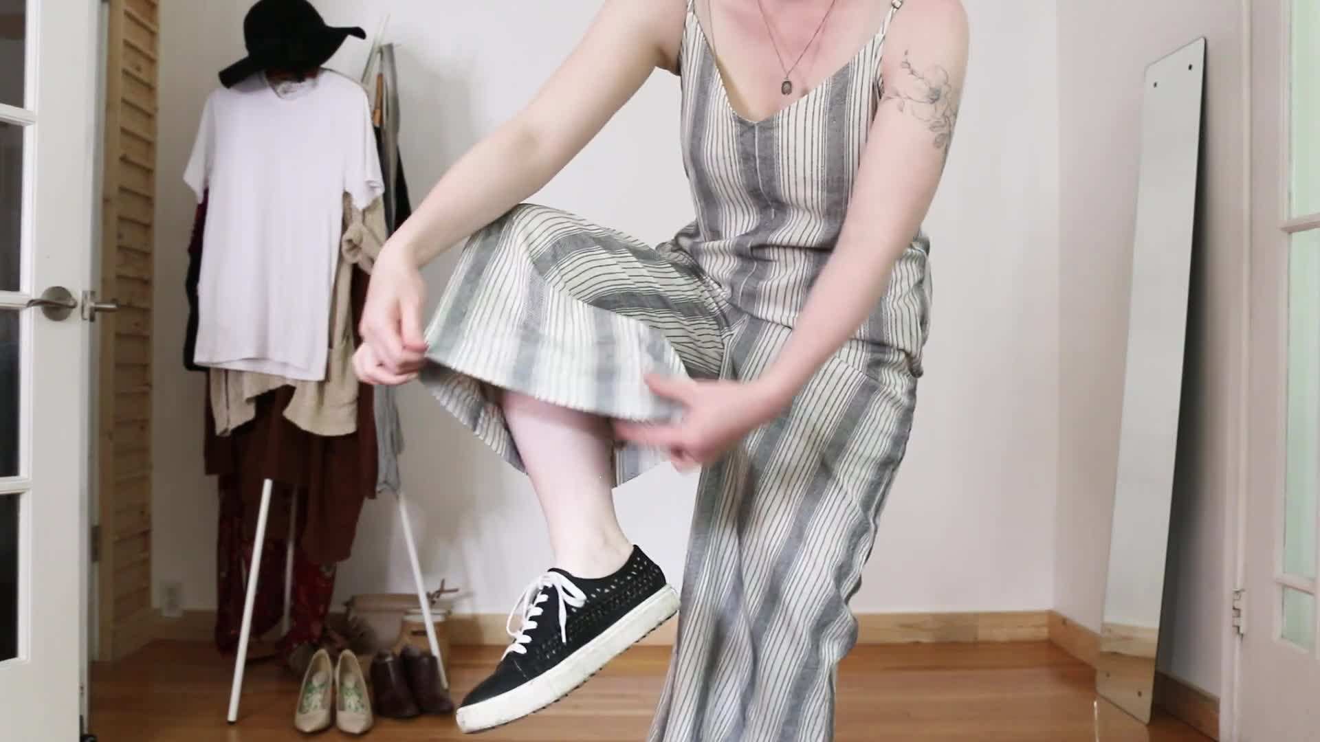 Example of a jumpsuit styled with a denim jacket and sneakers