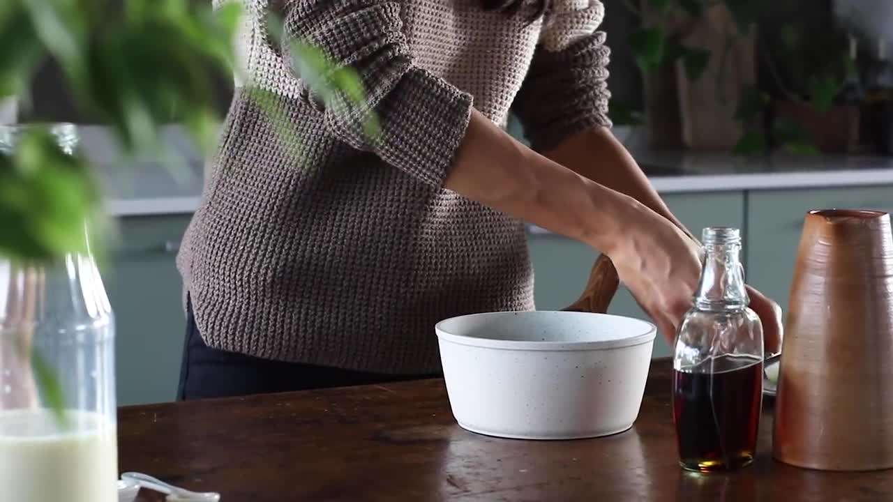 A steaming mug of hot chocolate topped with whipped cream and cocoa powder