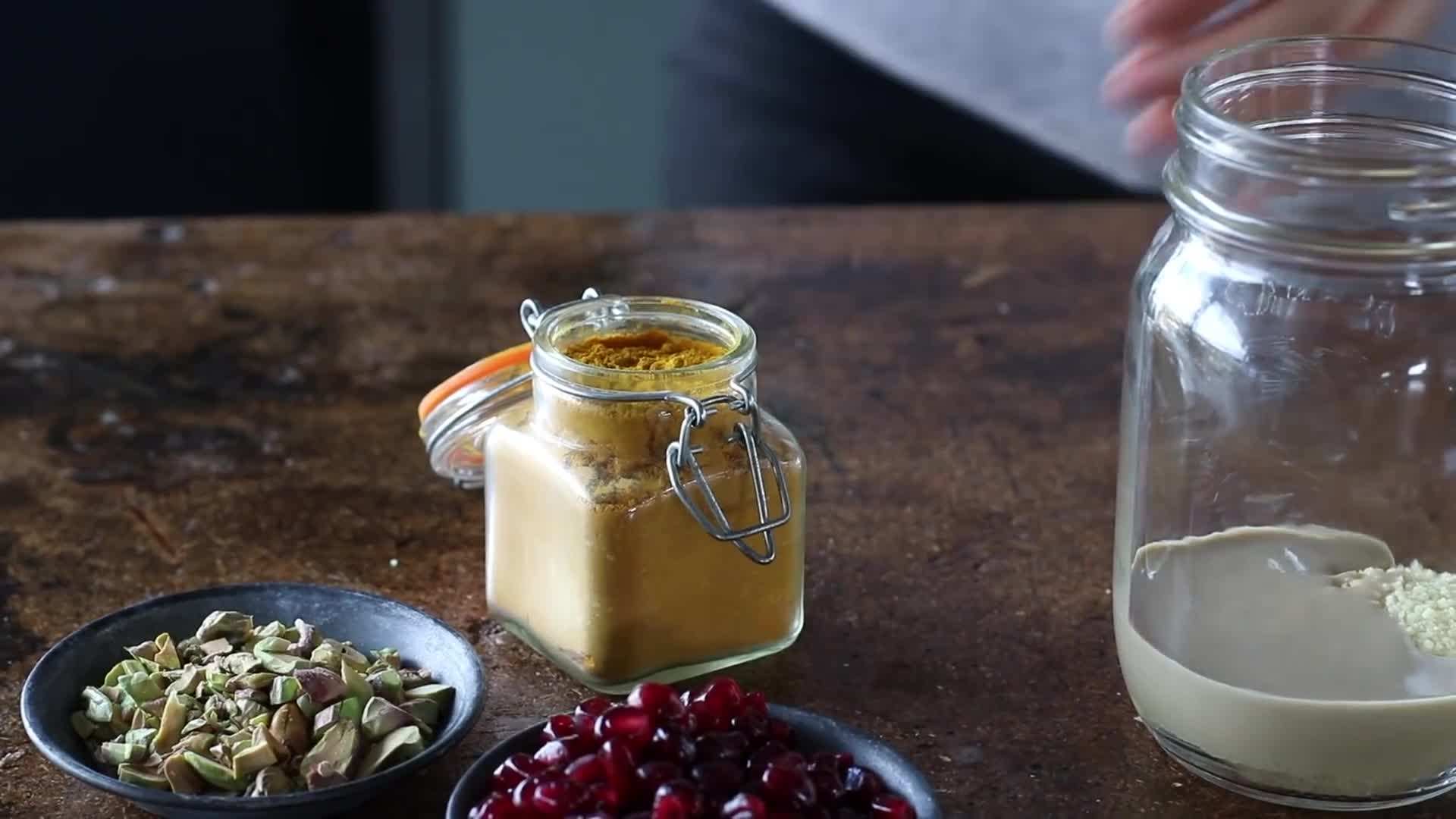 A jar of basic overnight oats topped with blueberries and almonds