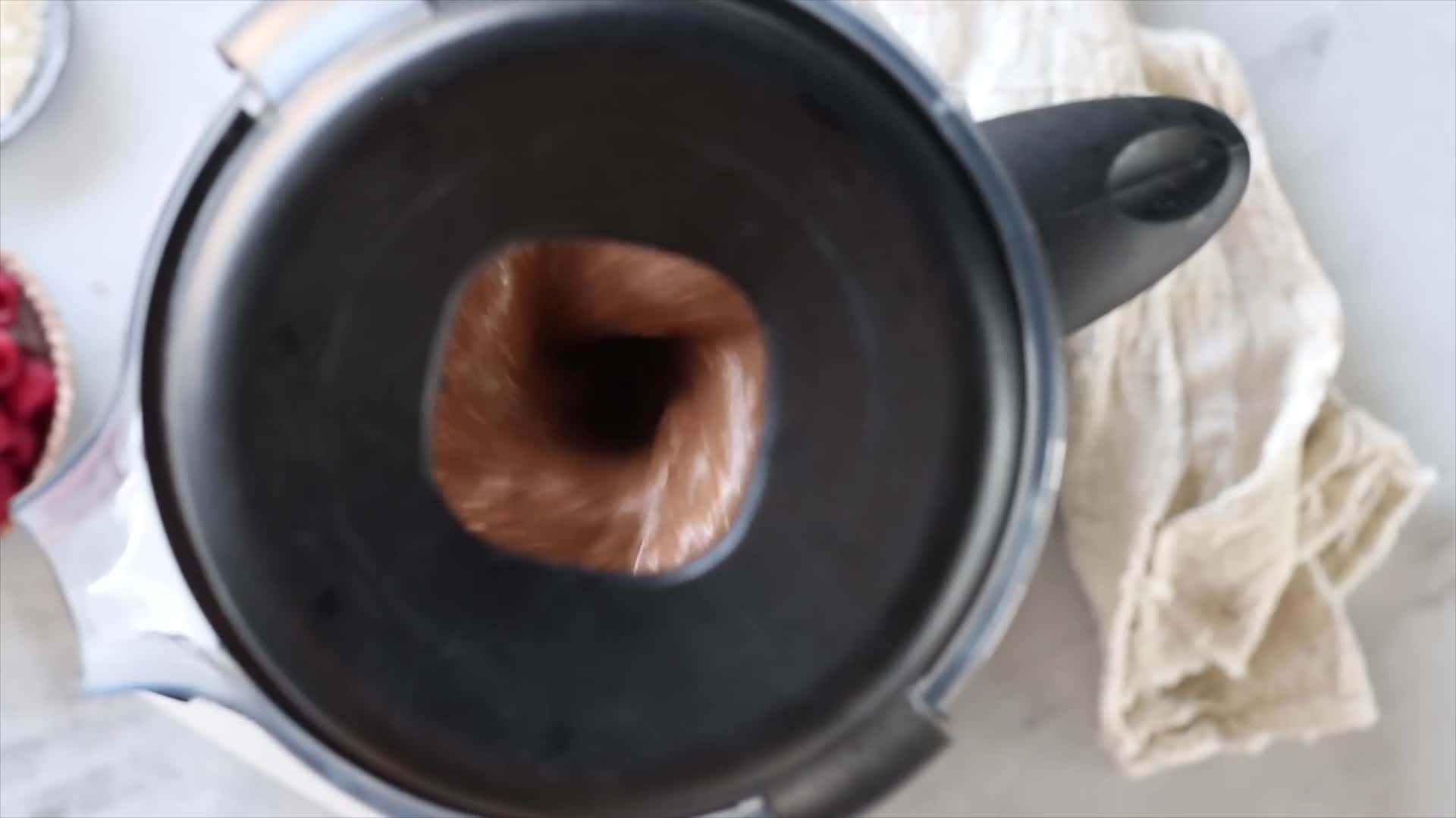 Pouring the chocolate banana smoothie into a glass