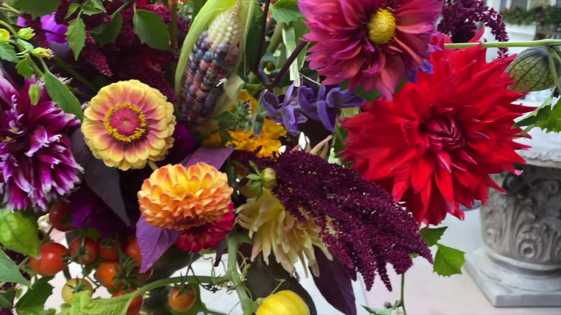 Hands arranging flowers in a vase