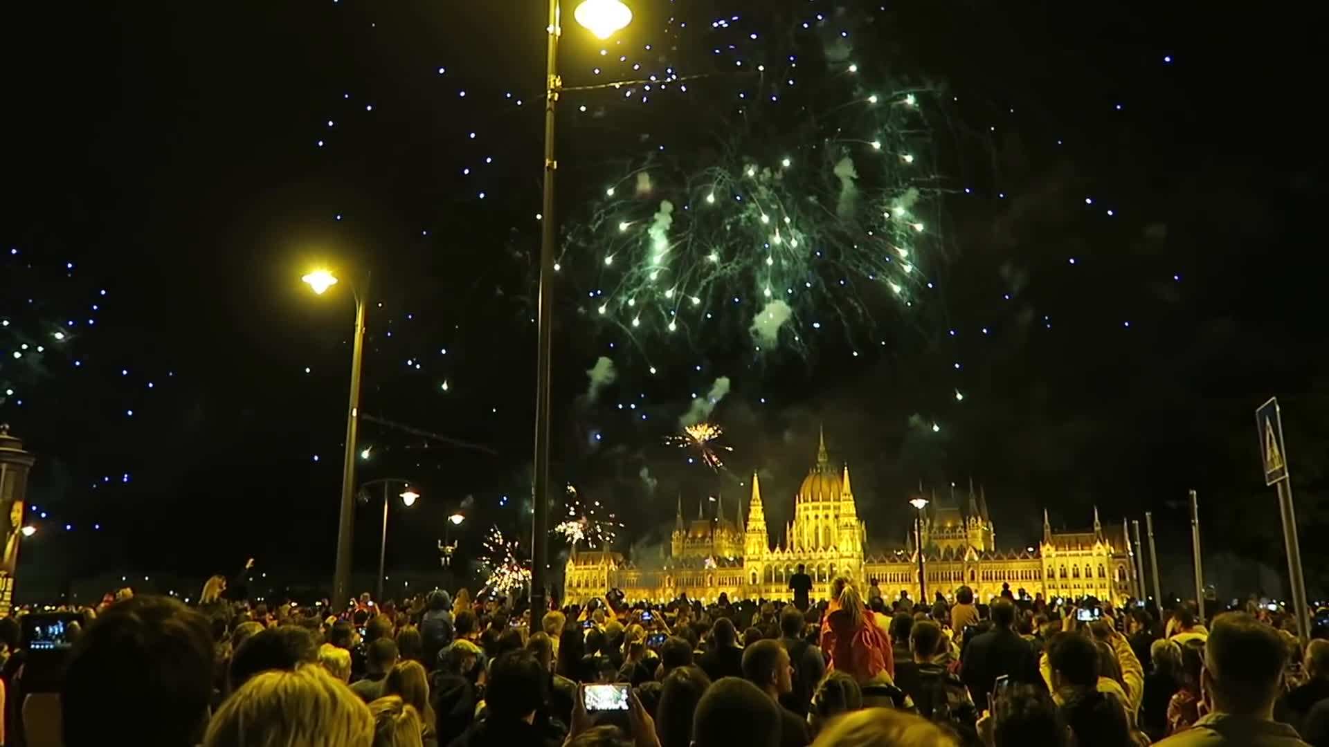 A mesmerizing fireworks display lighting up the night sky over the Danube River.