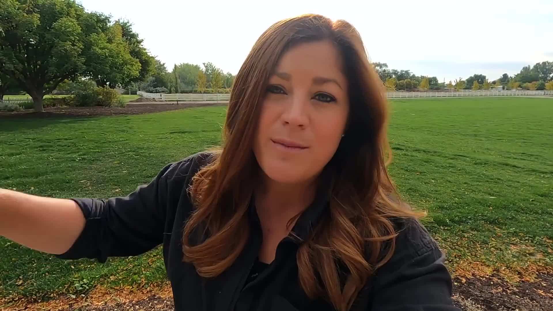 Spreading compost evenly over garden beds