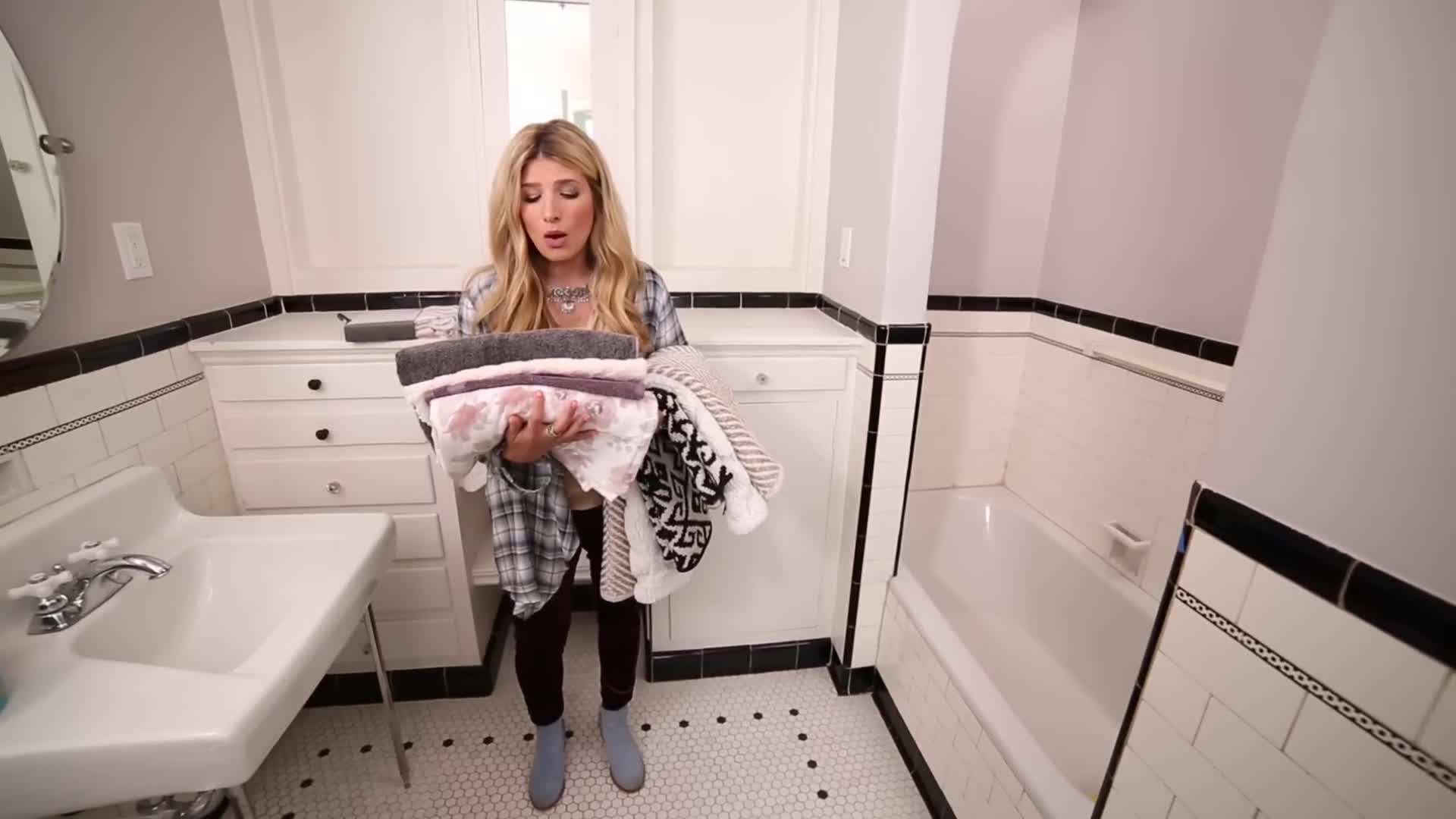 A bathroom with calming blue walls and potted plants