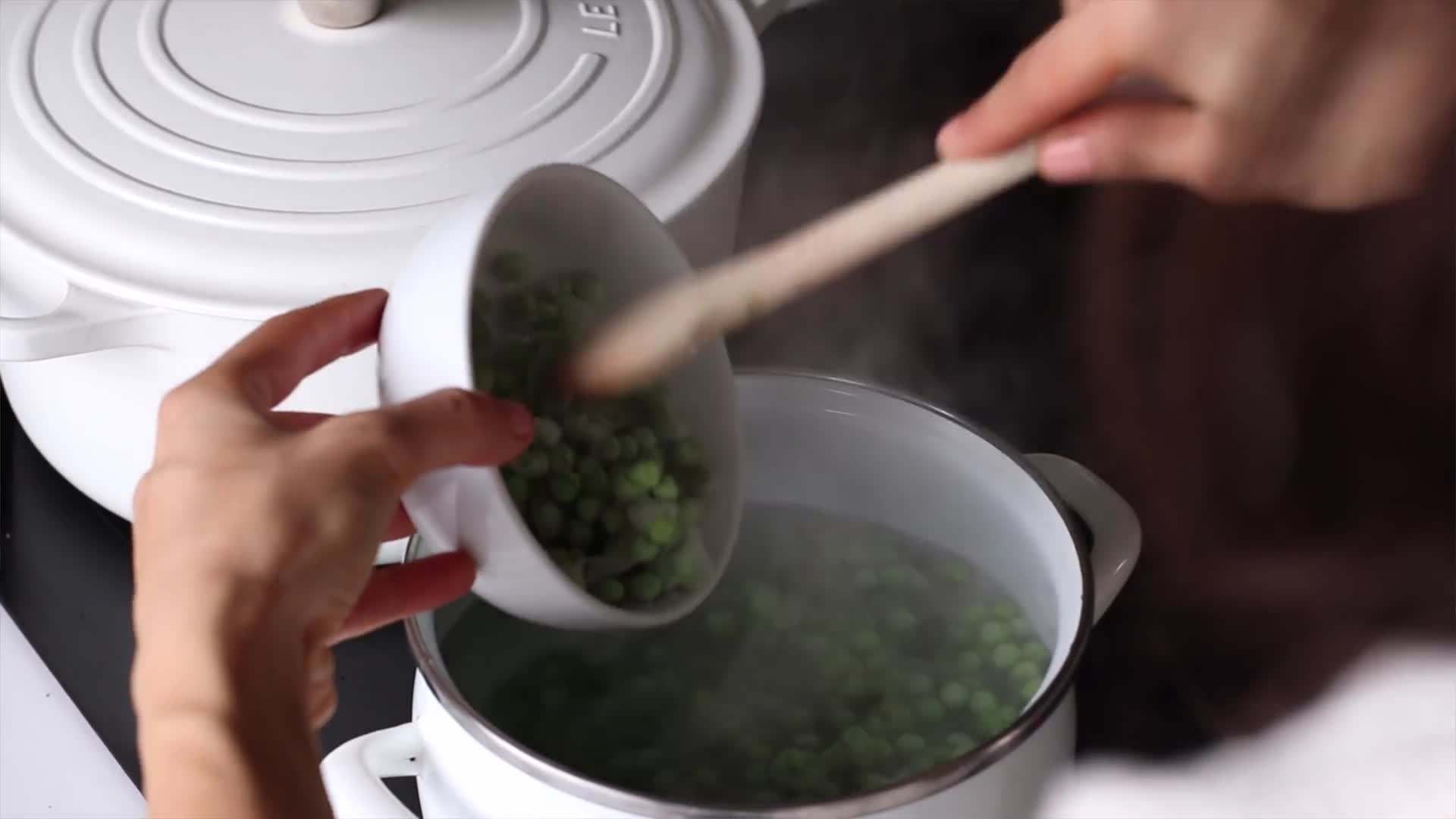 Sprinkling Smoked Paprika on Roasted Red Pepper Hummus