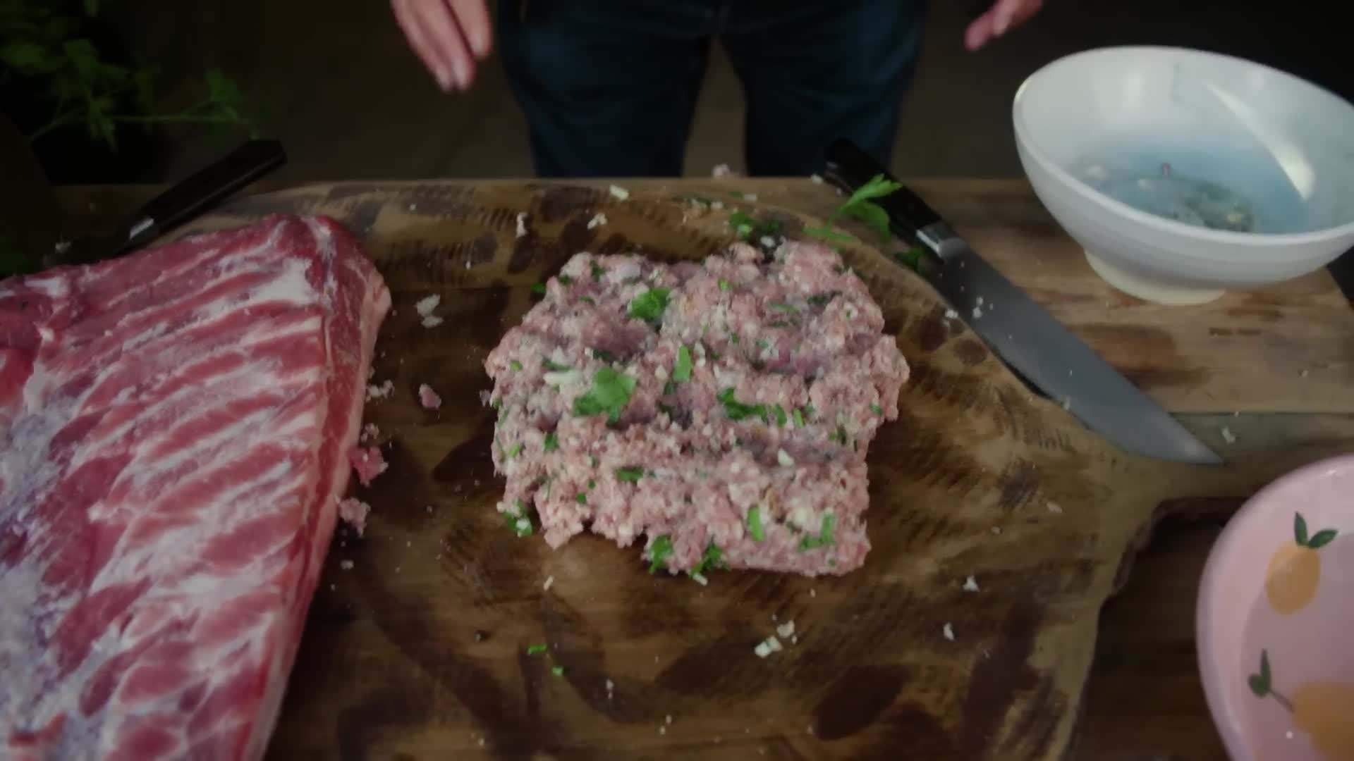Rolling the pork belly to create the perfect porchetta