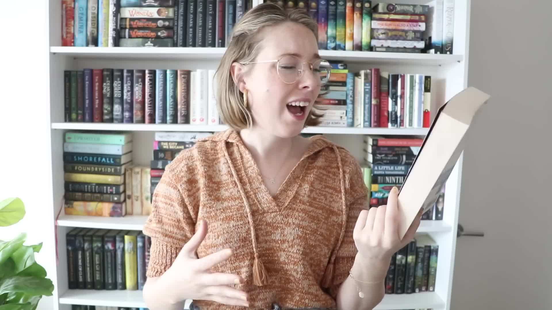 Sorting books into keep, donate, and sell piles