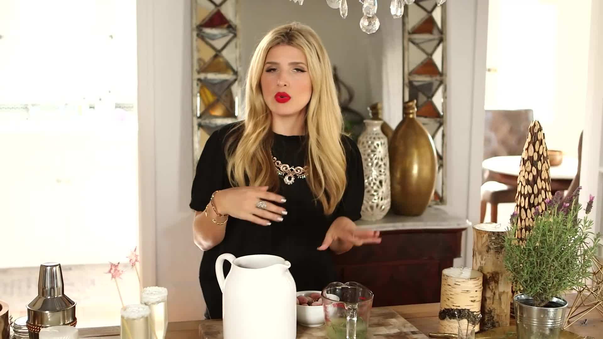 Glass of coconut bellini with pineapple and cherry garnish