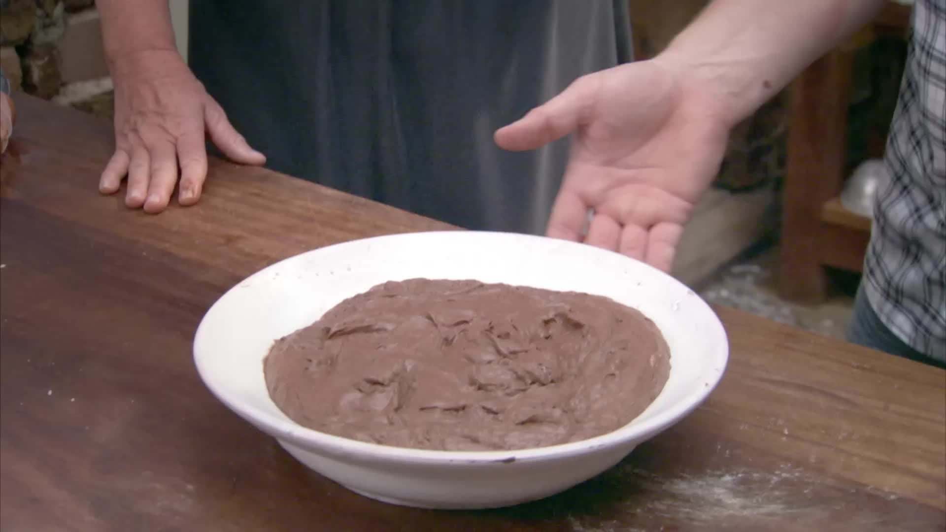 Spreading the crumbled ginger biscuits on the puff pastry