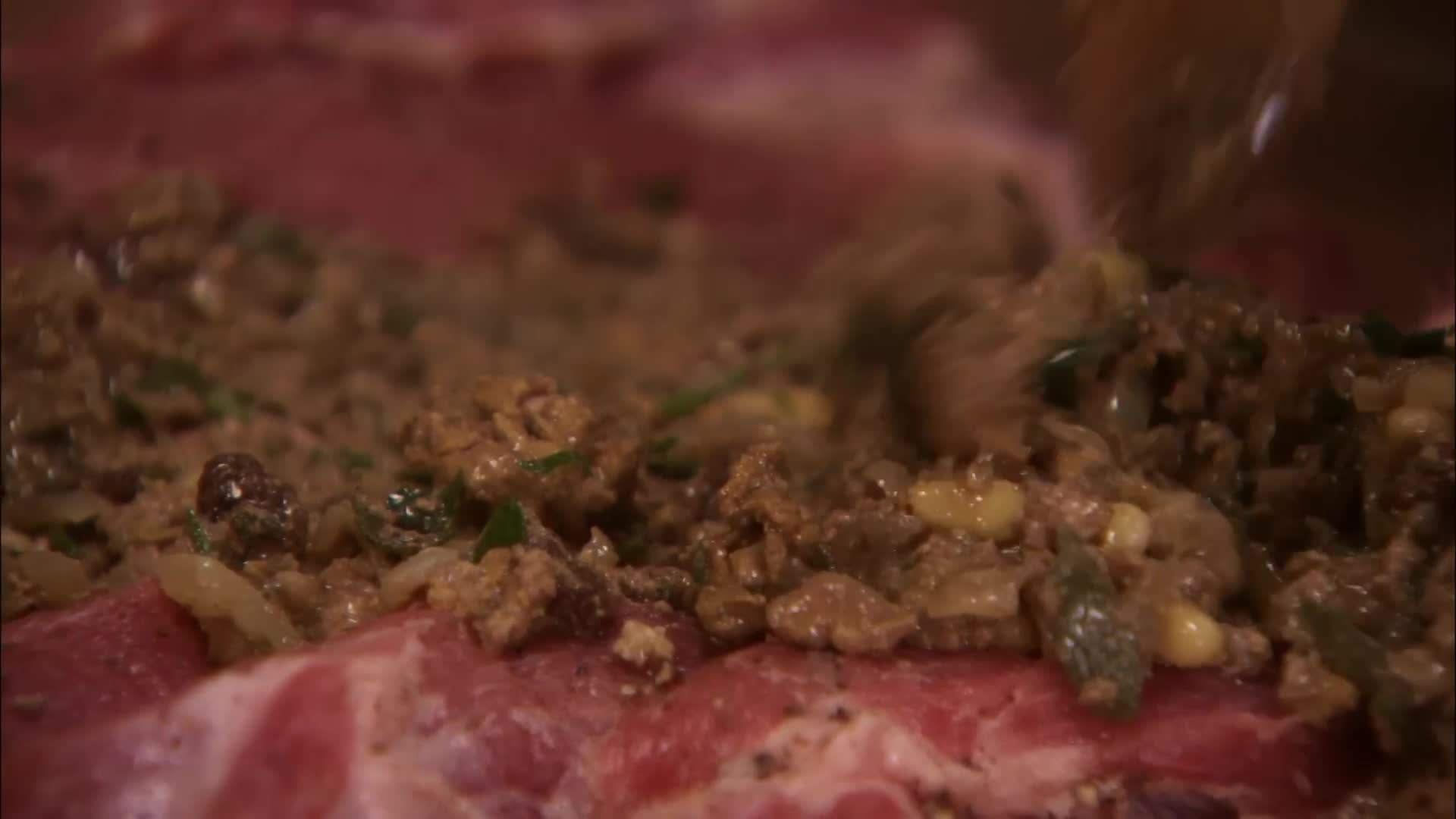The aromatic mixture of garlic, rosemary, and fennel seeds infusing the pork belly