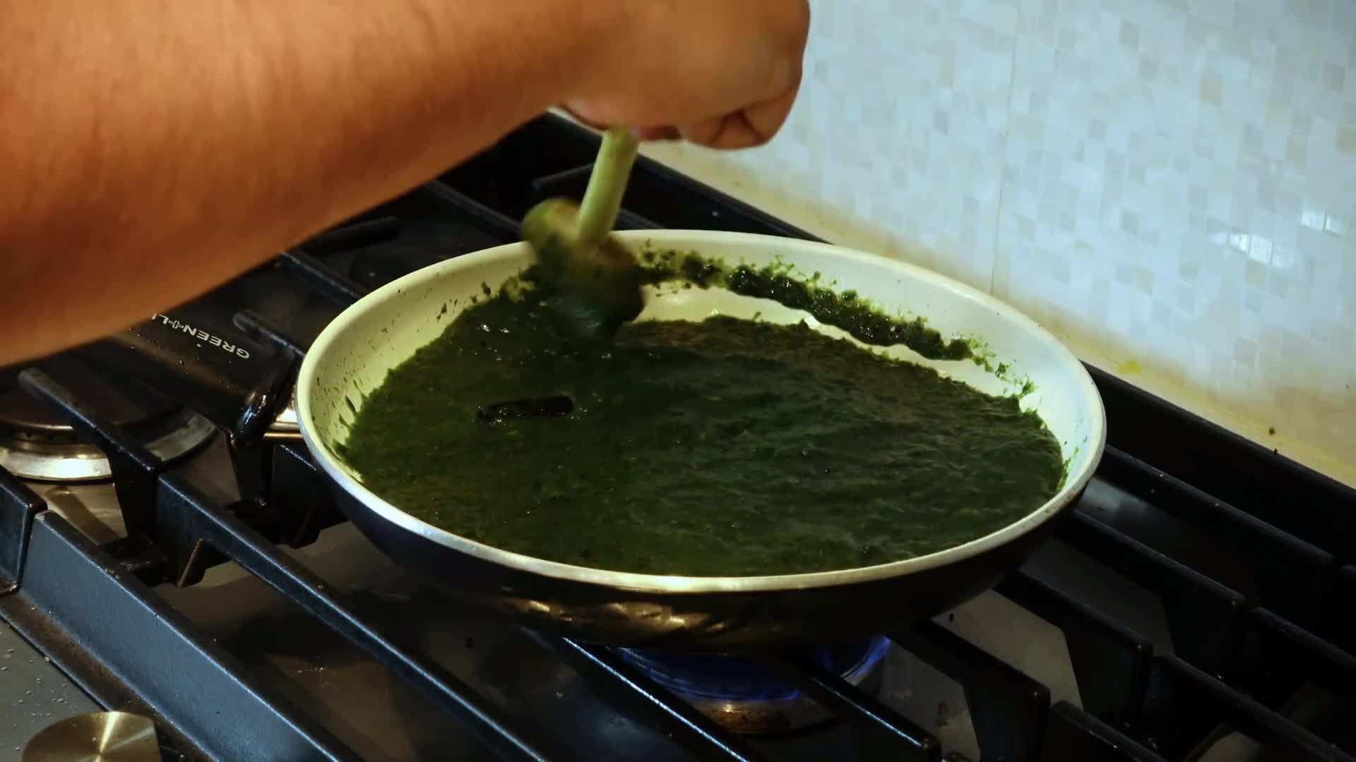 Drizzling the dressing over the salad