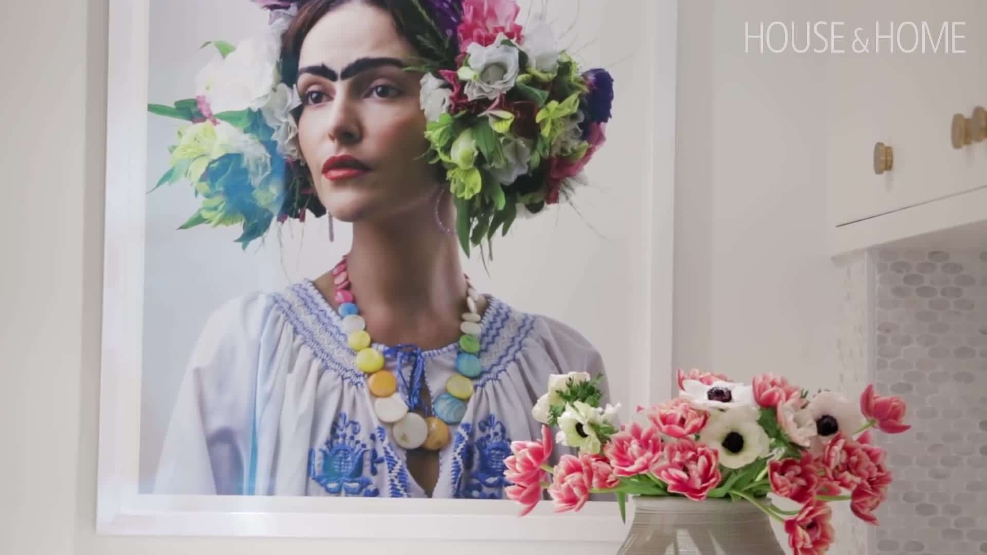Stephanie arranging decorative items on the open shelves in the kitchen