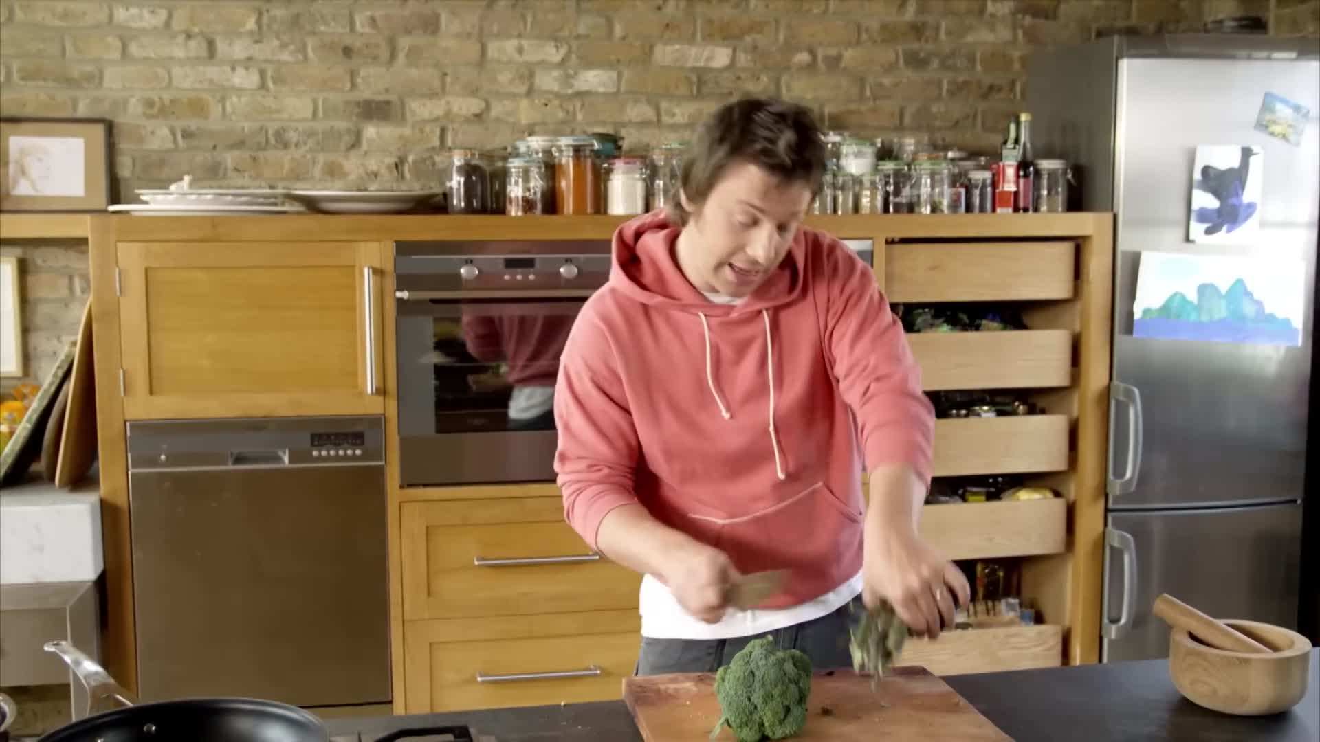Grilled chicken being added to the broccoli pasta