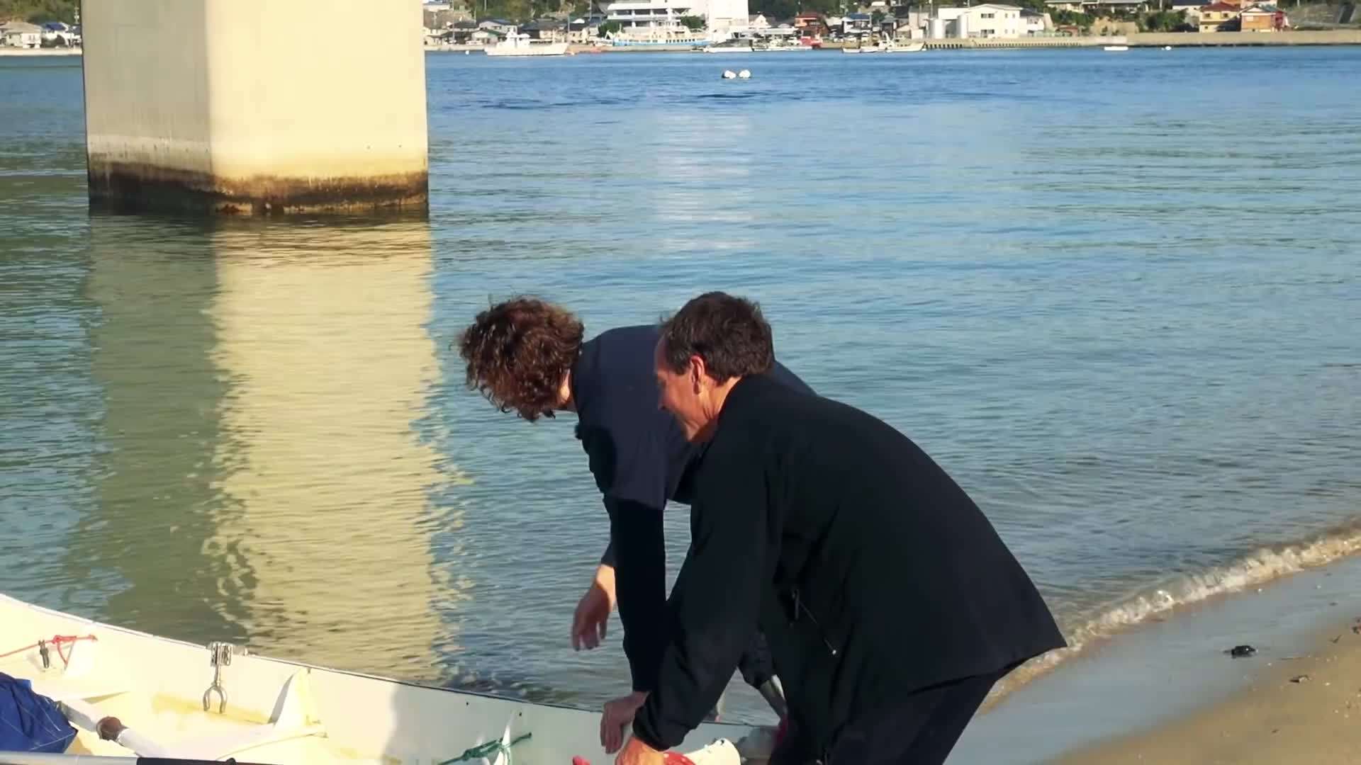 Sailboat sailing through crystal-clear waters of Japan