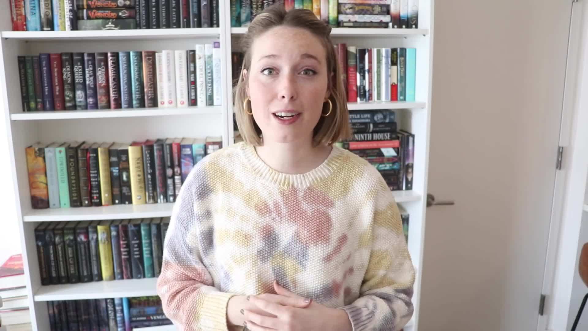 A stack of books representing the April TBR.