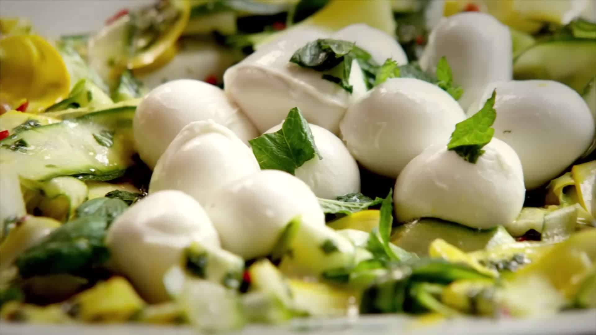 Broccoli pasta being served in a bowl