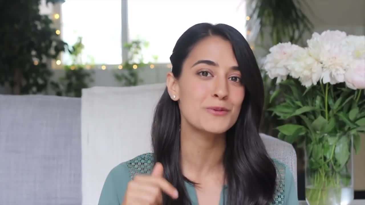 Visualizing Success: A person standing on top of a mountain with arms raised