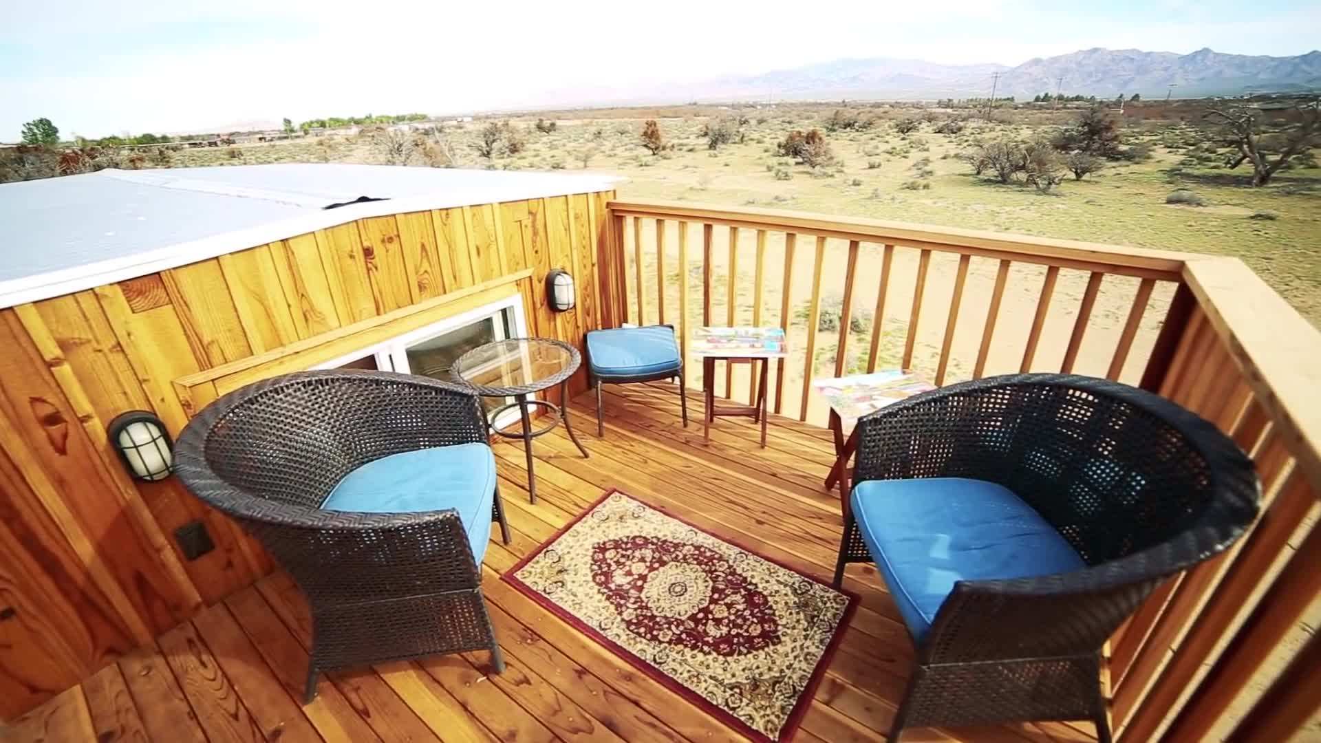 The Peacock tiny house's rooftop balcony offers stunning views of the Mojave Desert