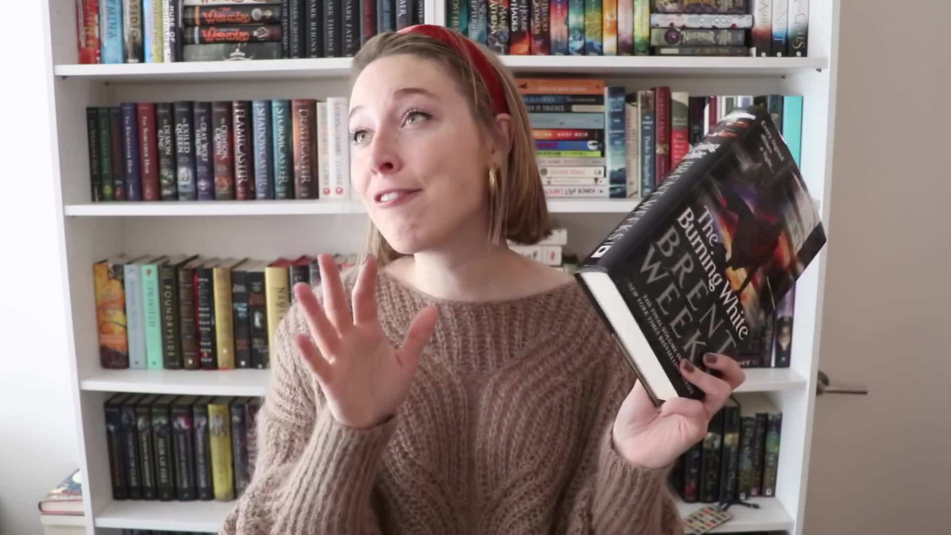 A person holding a thick book with a look of uncertainty
