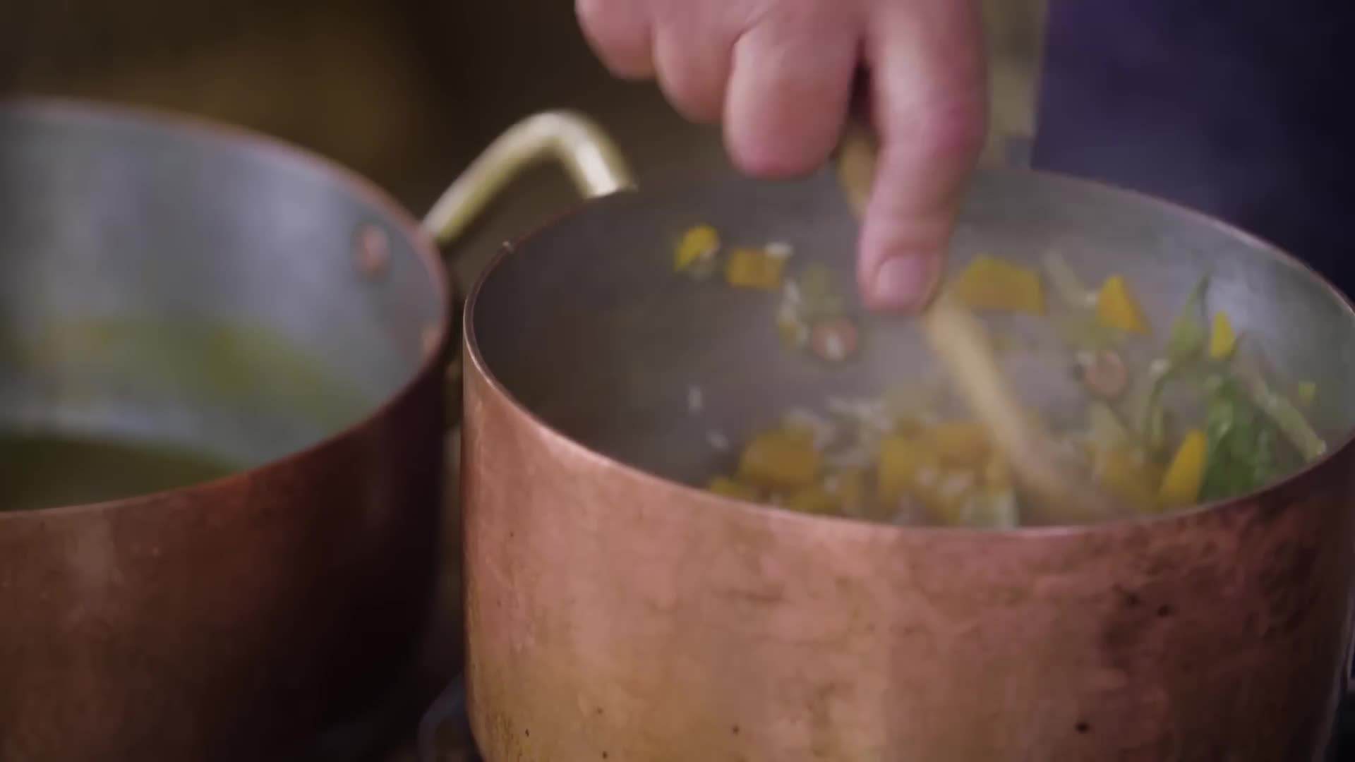 Stirring in the grated Parmesan cheese and fresh herbs